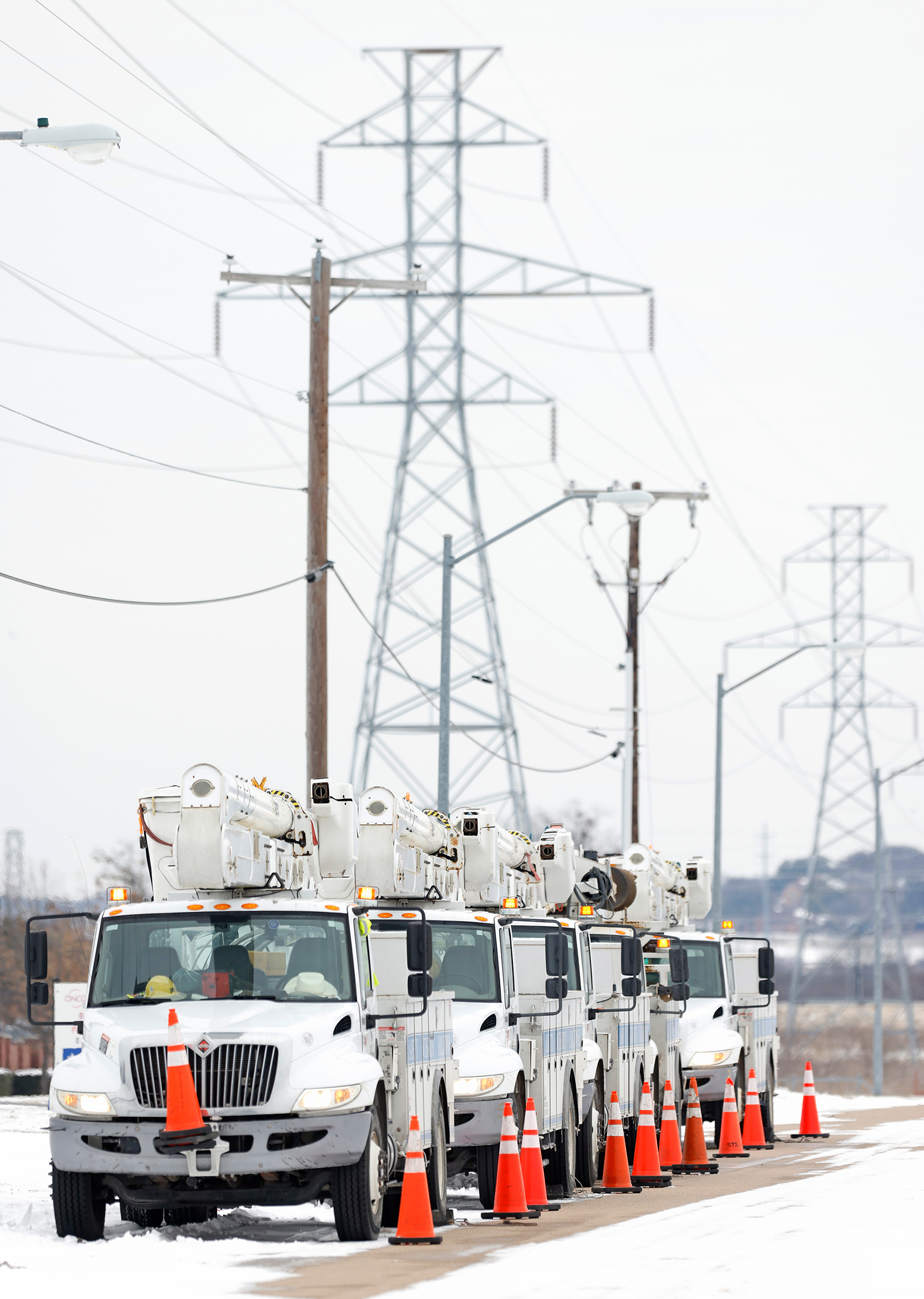Electric service trucks line up in Fort Worth after a snowstorm left millions of Texans without power (Ron Jenkins—Getty Images)
