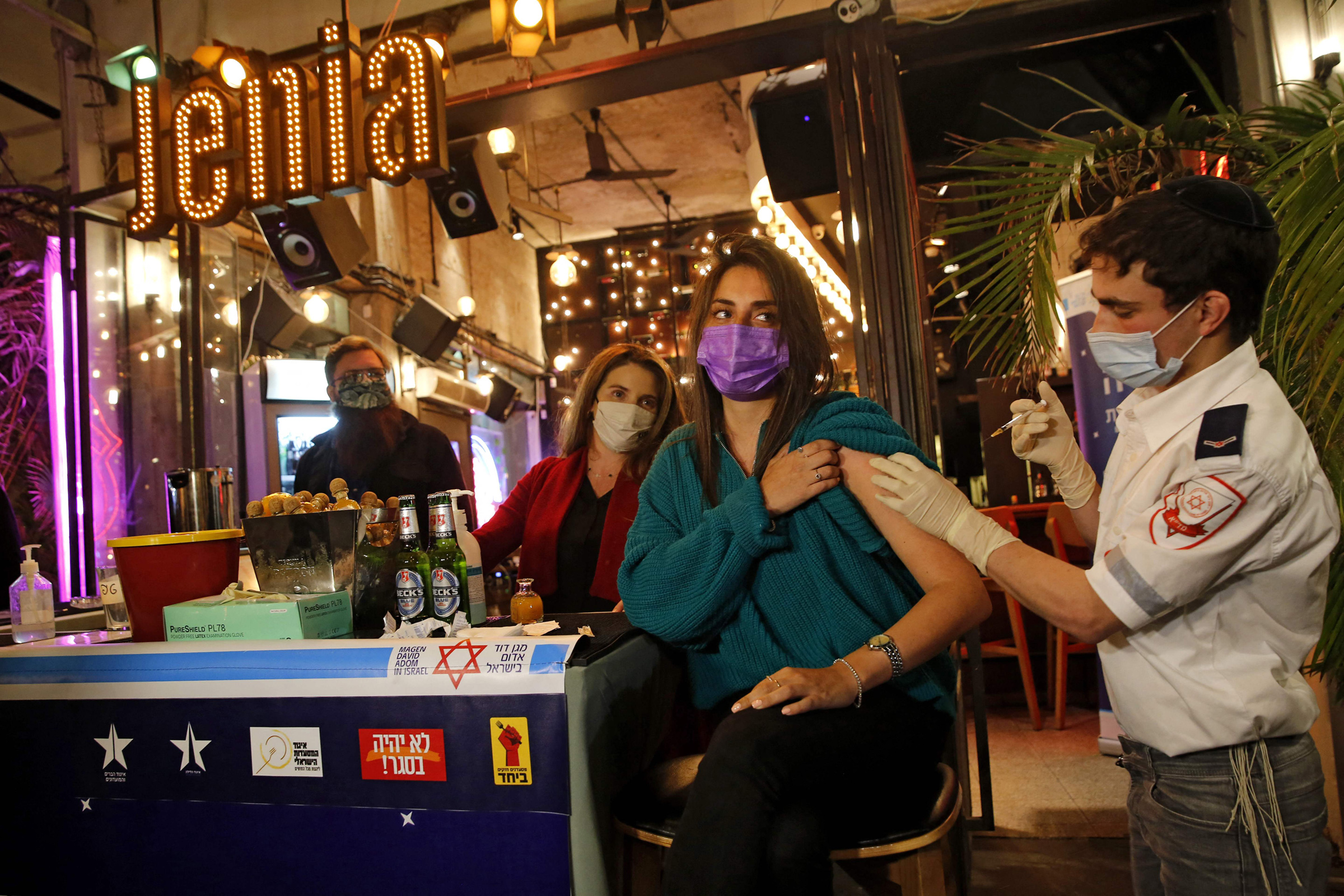 A health worker administers a COVID-19 vaccine at a bar in Tel Aviv on Feb.18, 2021. (Gil Cohen-Magen—AFP/Getty Images)
