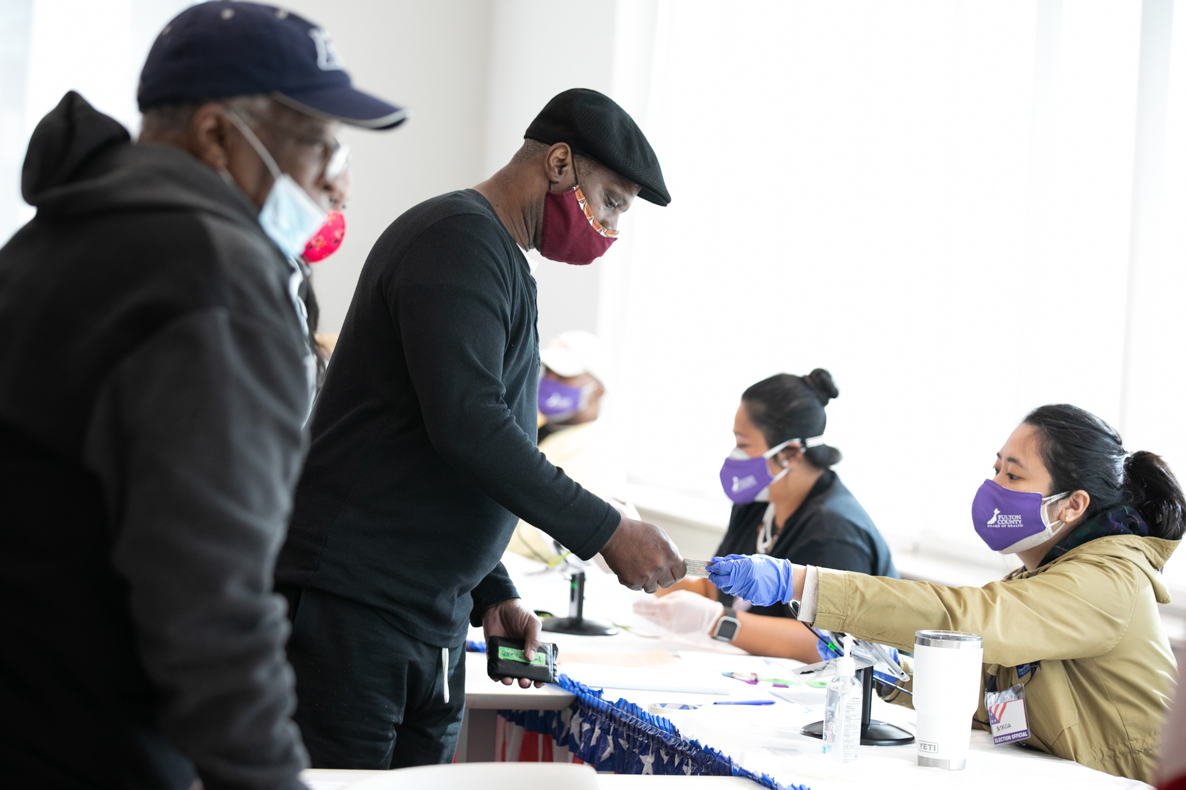 Voters check-in with poll workers to cast their ballots in Atlanta on Nov. 3, 2020. (Jessica McGowan—Getty Images)