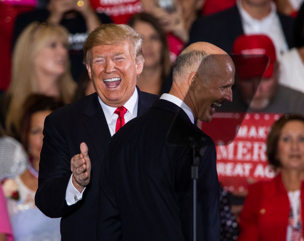 U.S. President Donald Trump welcomes Florida governor and US senatorial candidate Rick Scott at a campaign rally at the Pensacola International Airport in Pensacola, Florida, on November 3, 2018. (Mark Wallheiser—Getty Images)