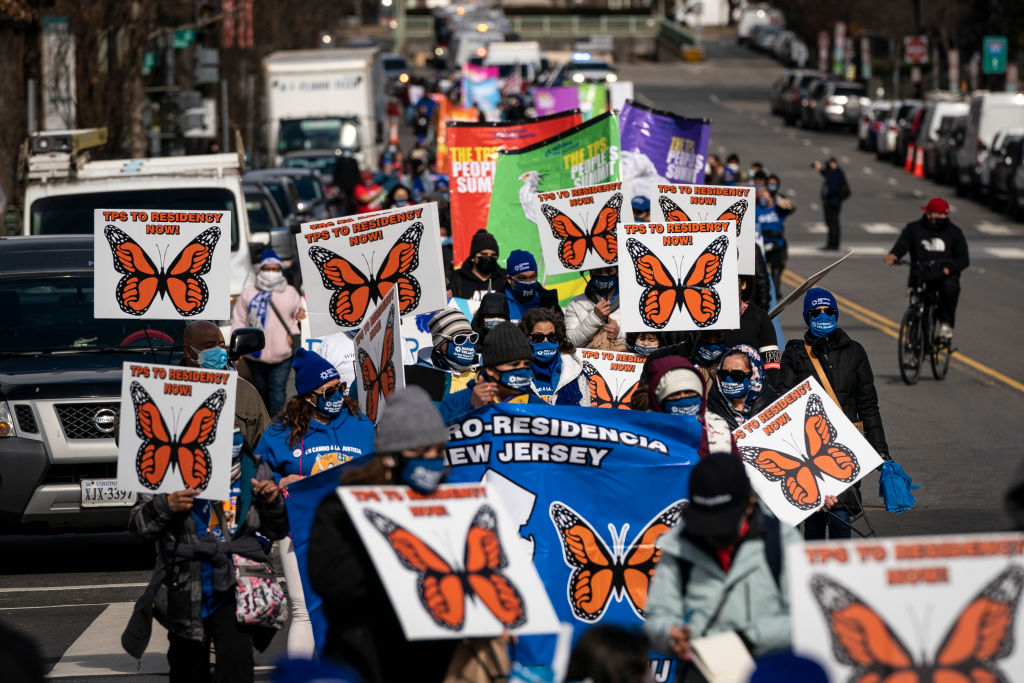 Activists and citizens with temporary protected status (TPS) march along 16th Street toward the White House in a call for Congress and the Biden Administration to pass immigration reform legislation in Washington, DC, on February 23, 2021. (Drew Angerer—Getty Images)