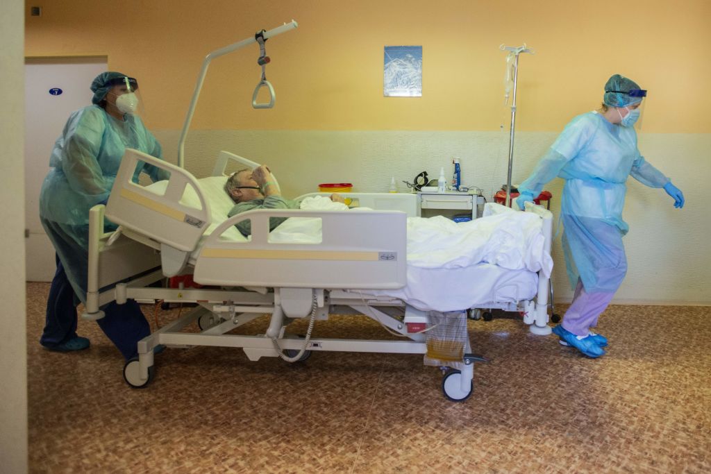 Nurses push a COVID-19 patient in his bed in an intensive care unit  at a hospital in Stod, Czech Republic, on Feb. 25, 2021 (Michal Cizek/AFP—Getty Images)