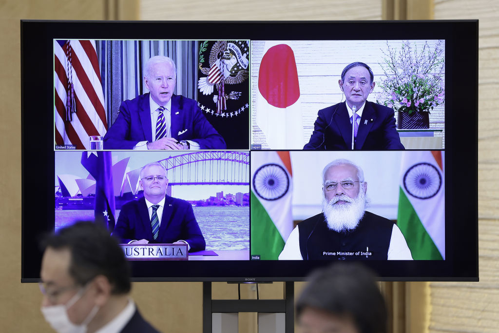 U.S. President Joe Biden, top left, Yoshihide Suga, Japan's prime minister, top right, Scott Morrison, Australia's prime minister, bottom left, and Narendra Modi, India's prime minister, on a monitor during the virtual Quadrilateral Security Dialogue (Quad) meeting at Sugas official residence in Tokyo, Japan, on Friday, March 12, 2021. (Kiyoshi Ota/Bloomberg)