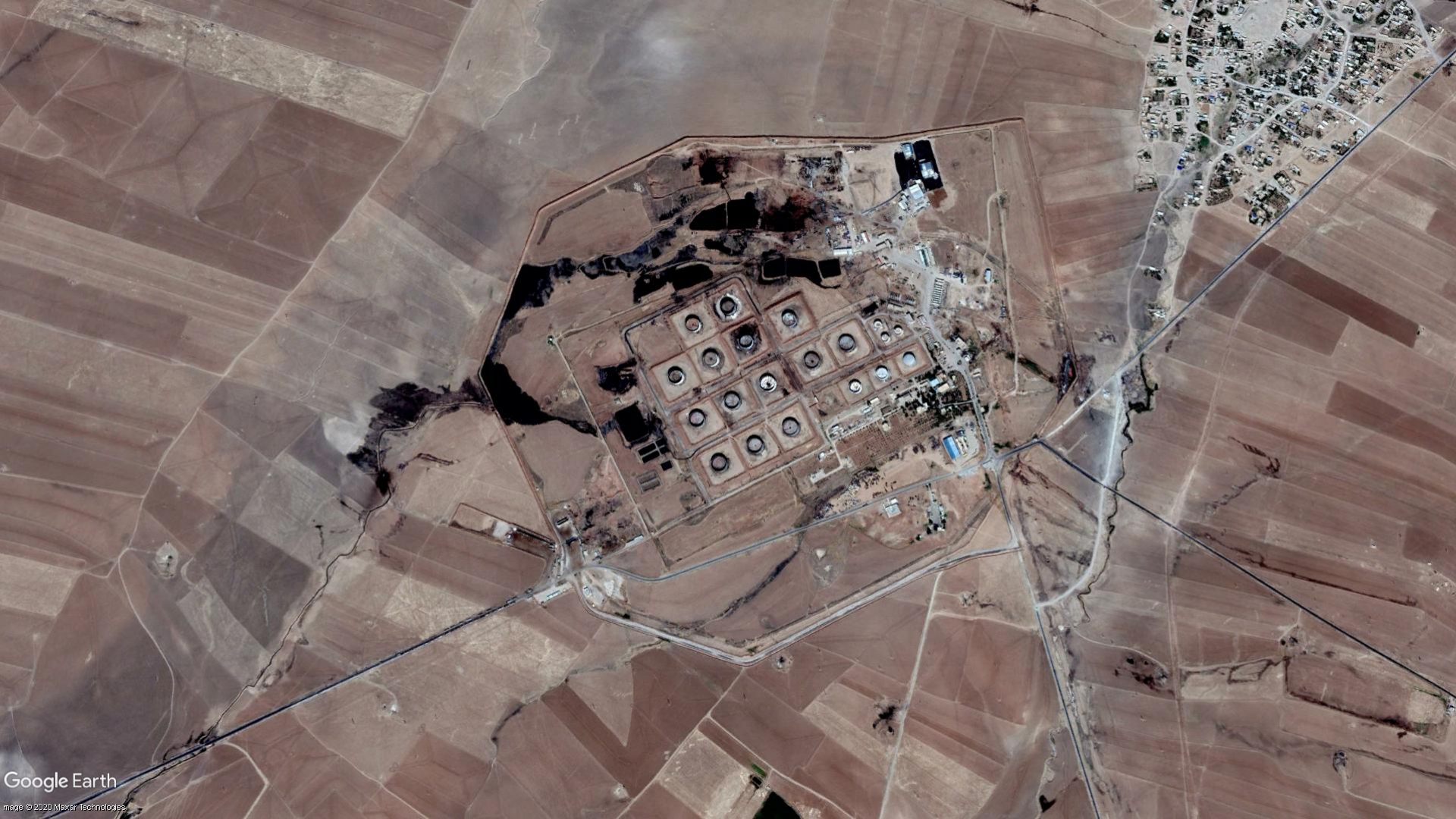 Crude oil and wastewater spills out of the Gir Zero oil storage facility at the Rmeilan oil fields in northeast Syria, in September 2019.