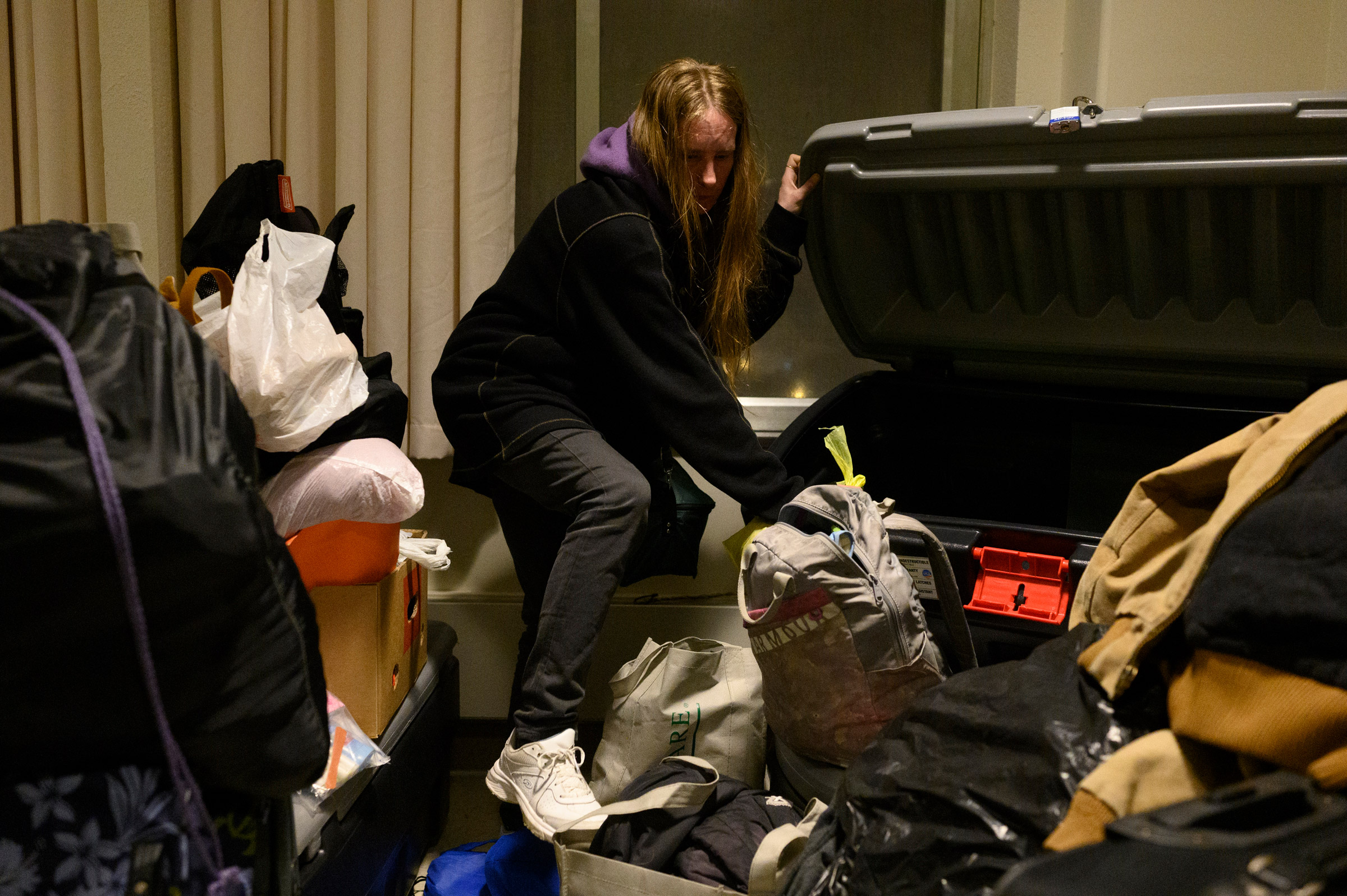Dylon collects belongings that she has stored at the Winter Freeze shelter on its final night of operation for the year in Wheeling, WV on December 15, 2021.