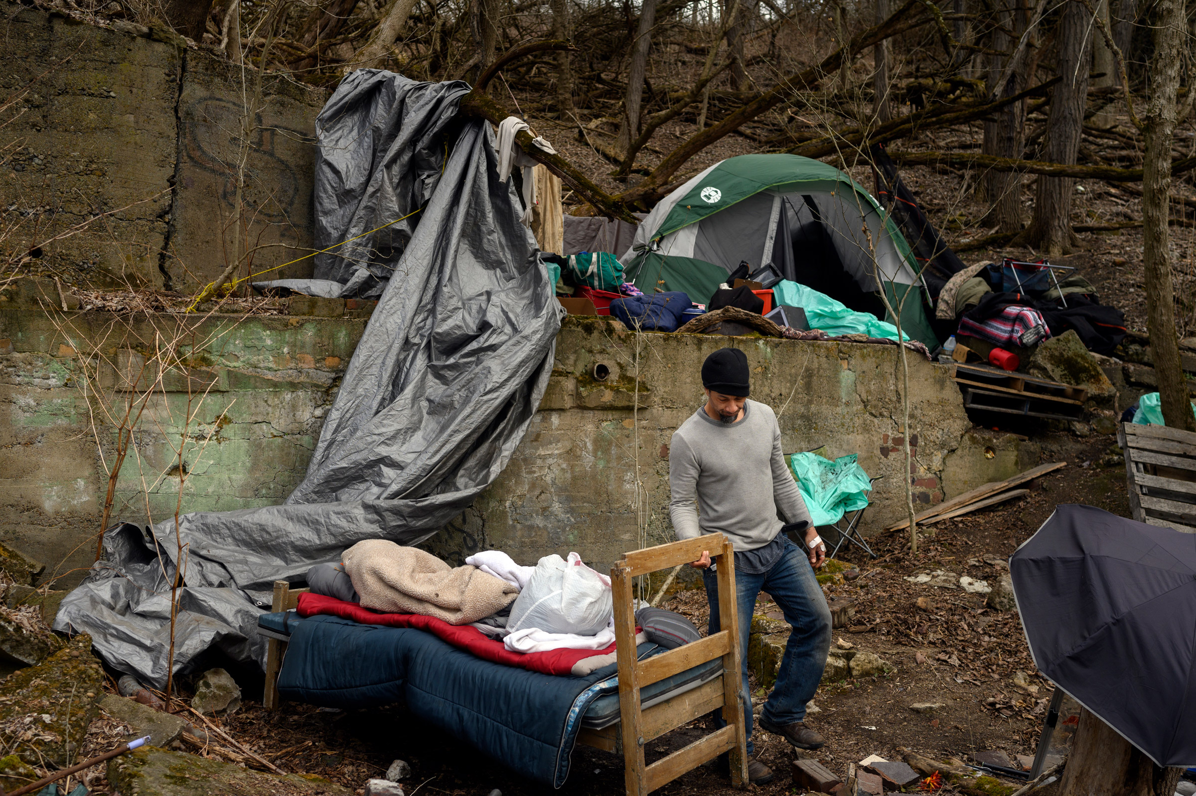 A man who goes by the name “Seven” builds up his tent encampment in Wheeling, WV on March 16, 2021. When the Winter Freeze shelter closed for the year, the unhoused population had to prepare to live outside for the remainder of the year.