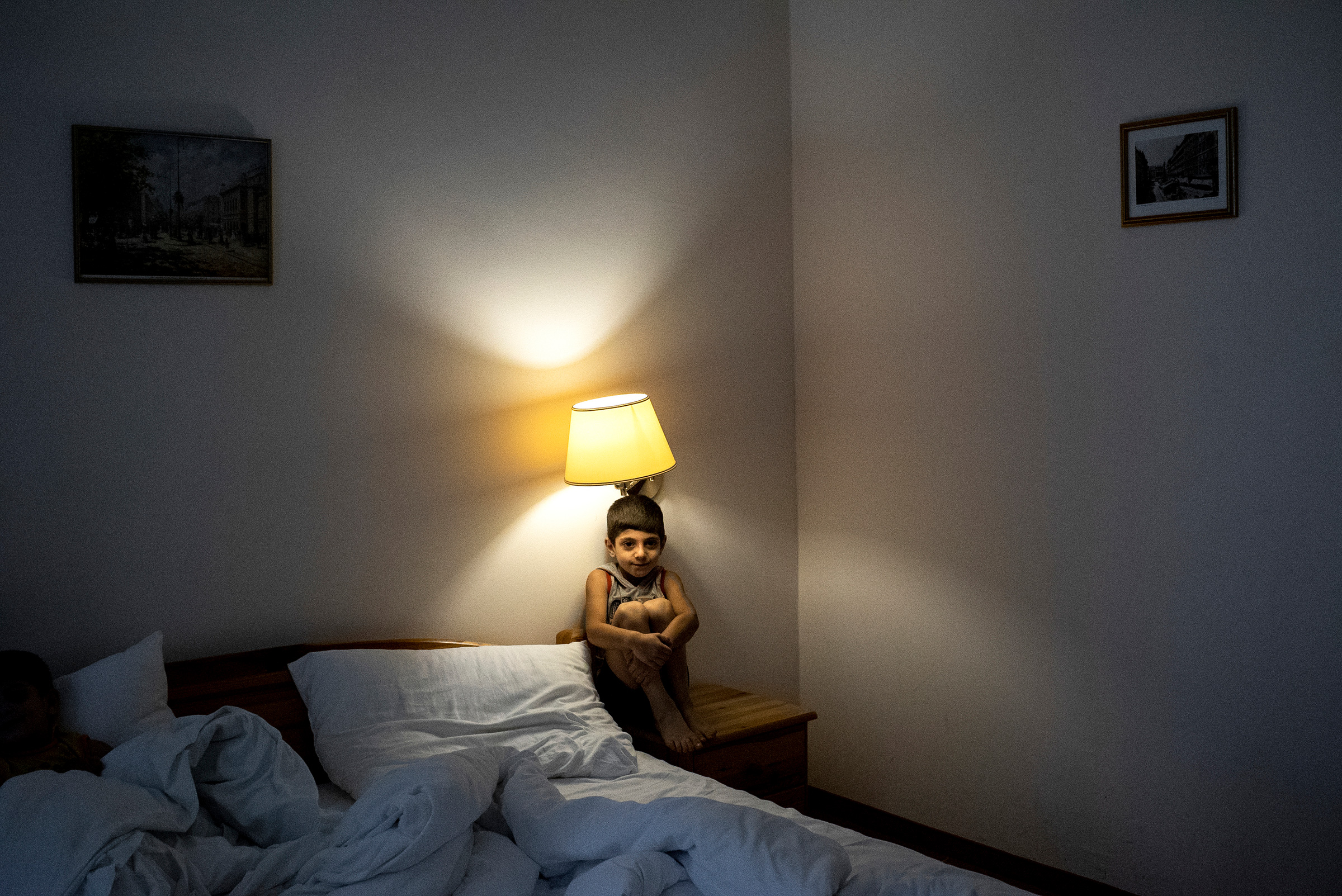 Ali, a Syrian refugee who arrived that evening in Vienna with his family after weeks on the refugee trail. The next day they continued their journey to a new life in Sweden. Vienna, 2015. (Peter van Agtmael—Magnum Photos)