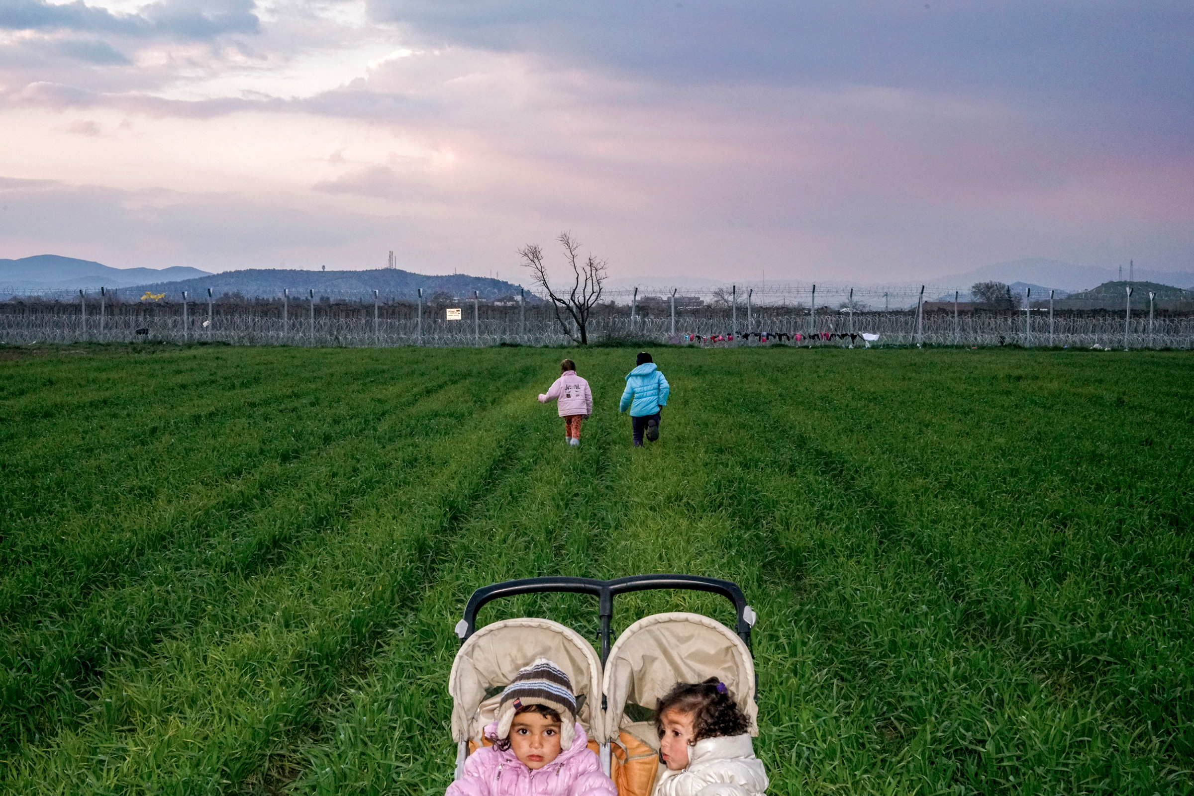 Children in the Idomeni refugee camp on the Greece-Macedonia border after Macedonia sealed its border. Idomeni. Greece, 2016. (Peter van Agtmael—Magnum Photos)