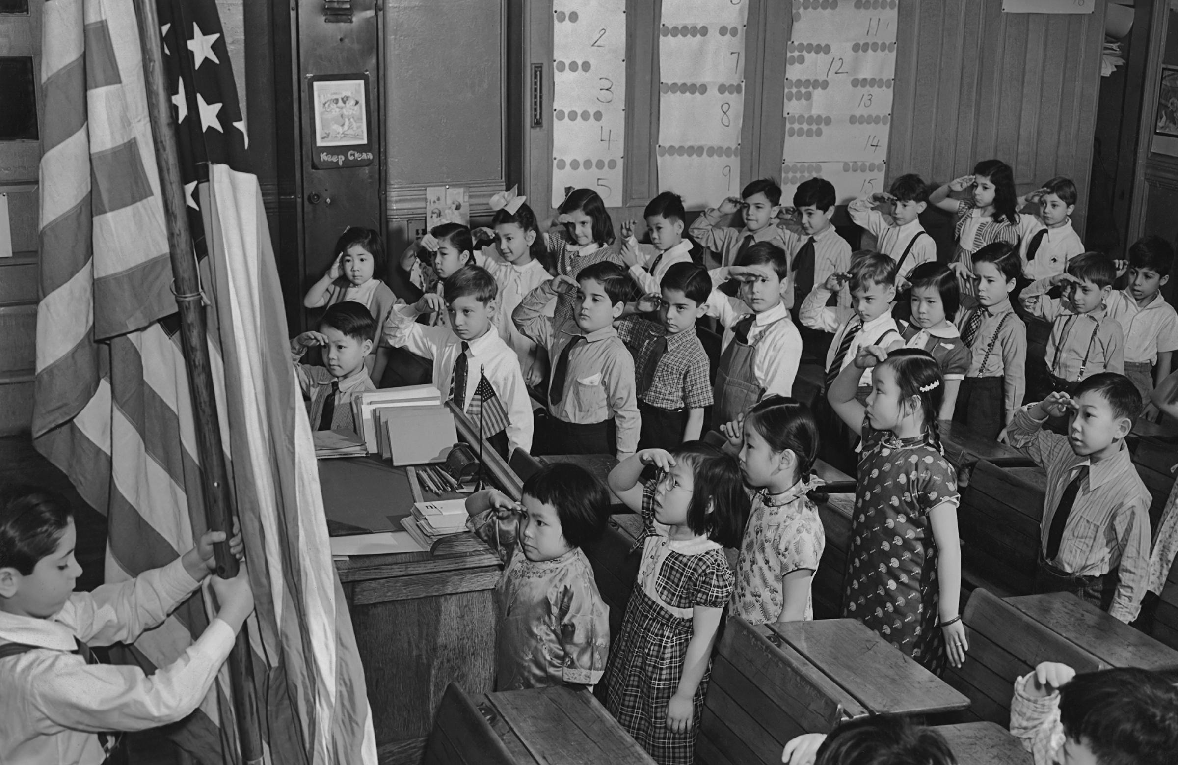A group of children saluting the American flag at a school in the Chinatown area of Manhattan circa 1960. (Keystone View/FPG/Getty Images)