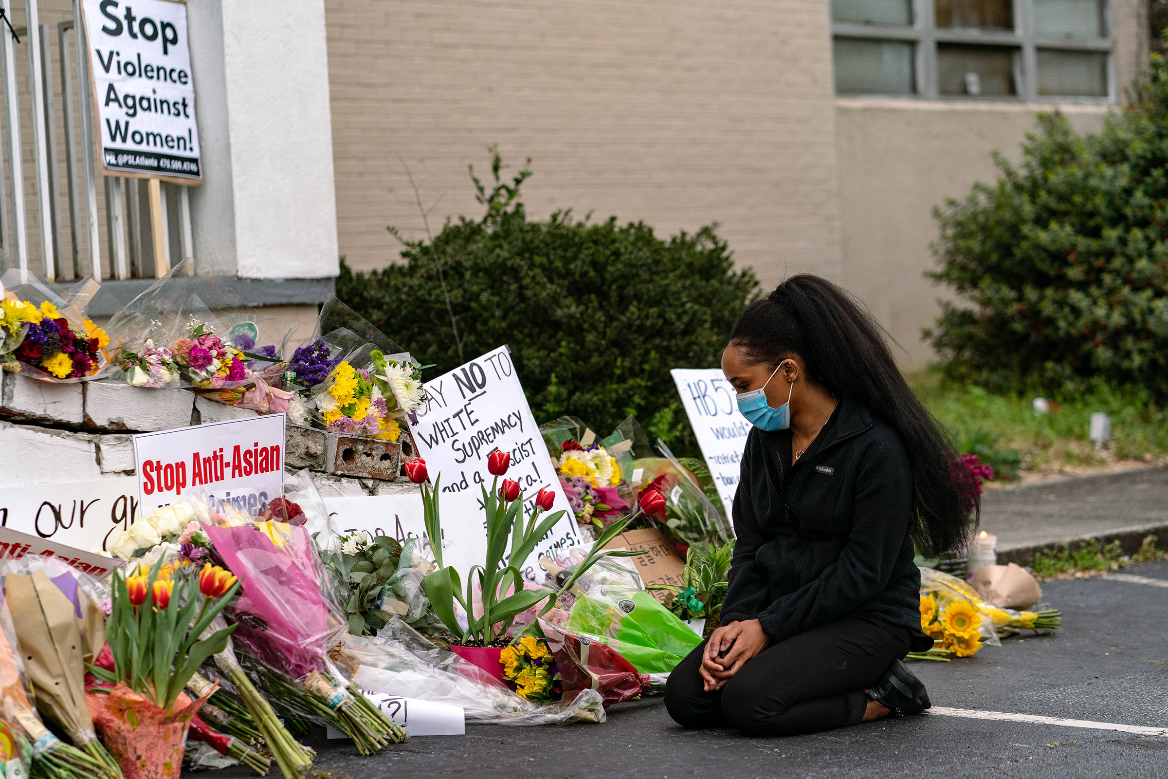 A mourner at a makeshift memorial for the victims of a shooting at Gold Spa in Acworth, Ga., March 19