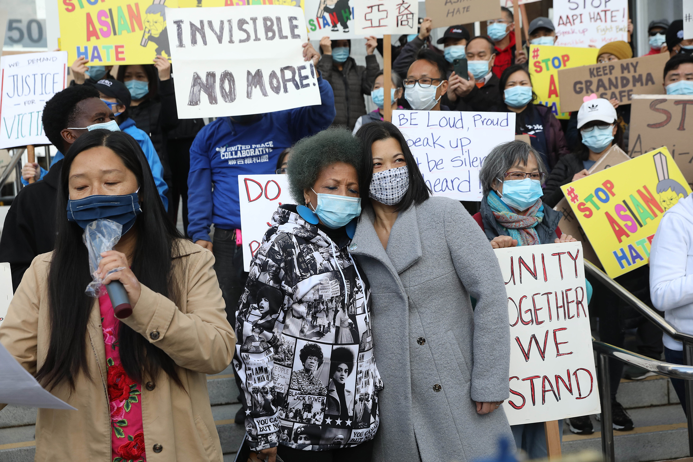 Mattie Scott (center, left to right), founder and Executive Director of Healing 4 Our Families & Our Nation and Nancy Tung, public safety advocate, hold each other as they rally with demonstrators rallying in front of the Hall of Justice as they demand justice for Vicha Ratanapakdee on March 22 in San Francisco