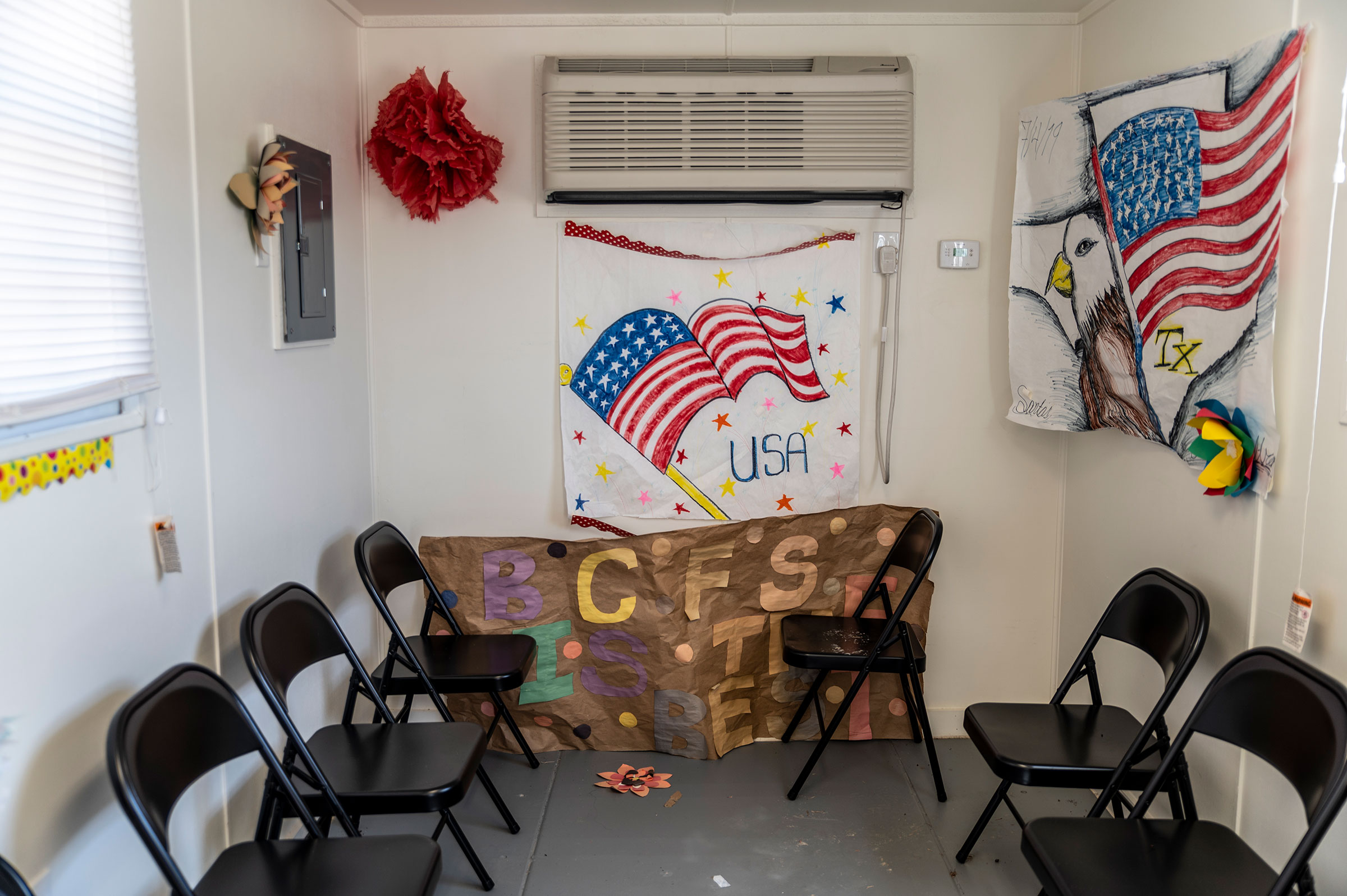 Artwork made by previous residents hangs inside a welcome center at a Influx Care Facility for unaccompanied children in Carrizo Springs, TX  on Feb. 21, 2021. (Sergio Flores—The Washington Post/Getty Images)