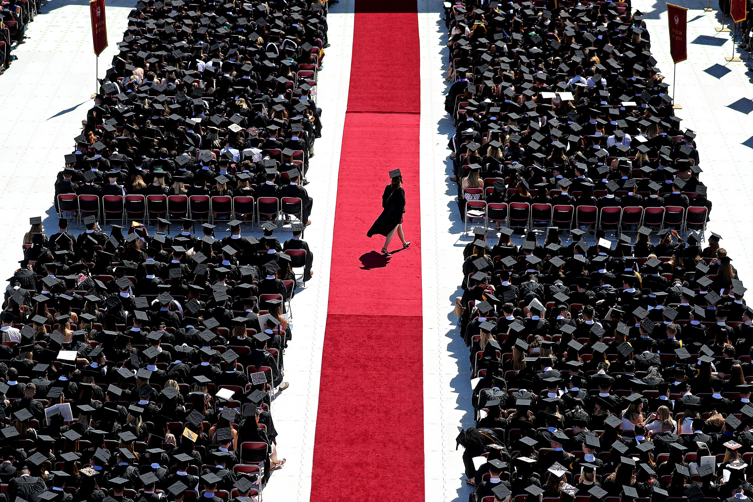 A graduate crosses the red carpet at Boston College’s commencement on May 21, 2018 (David L. Ryan—The Boston Globe/Getty Images)