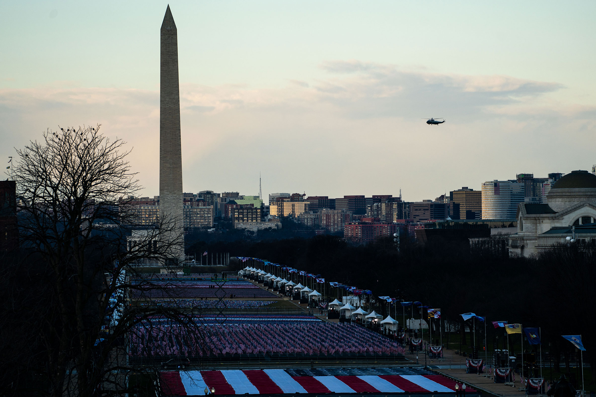 Marine One flies by the Washington Monument as President Donald Trump departs Washington on the morning of the 59th Presidential Inauguration ceremonies on Jan. 20, 2021. (Kent Nishimura—Los Angeles Times/Getty Images)