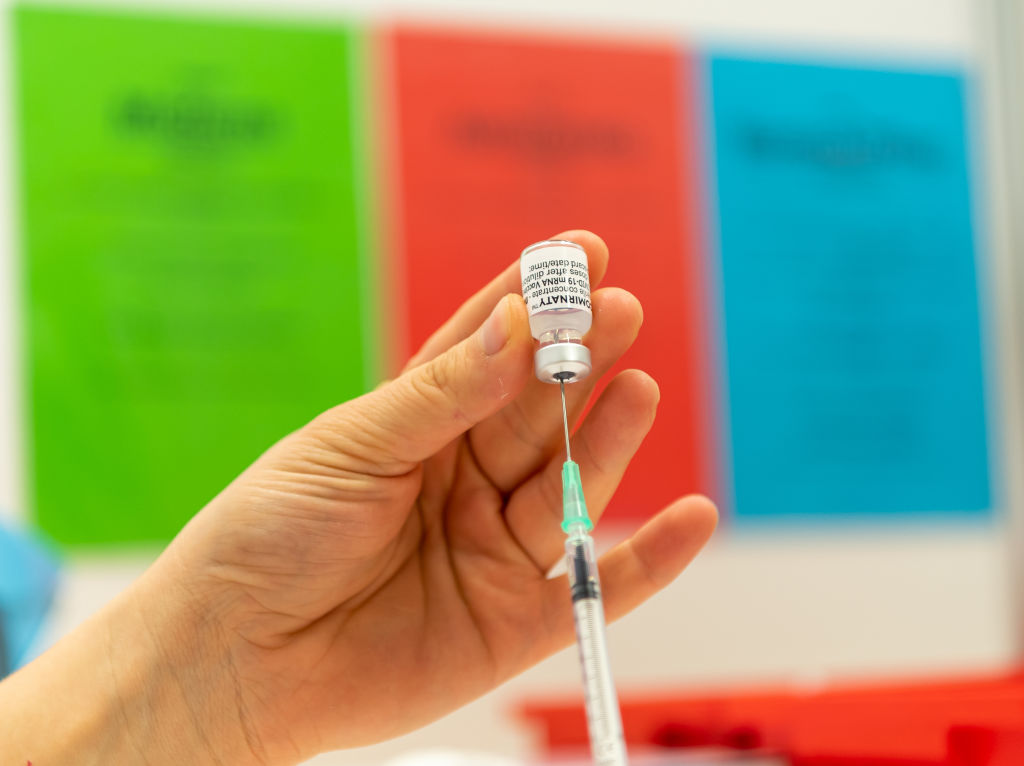17 March 2021, Bavaria, Fürstenfeldbruck: An employee of the Red Cross draws up a syringe with Pfizer BioNTech vaccine in the laboratory of the Coronavirus Vaccination Center Fürstenfeldbruck. Vaccinations can continue at the vaccination centre, now that second vaccinations with Pfizer-BioNTech are planned in particular. (Peter Kneffel/dpa)
