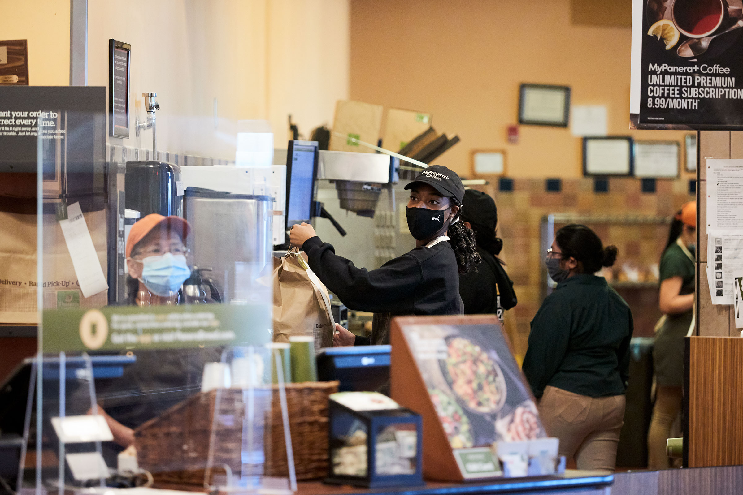 Joseph readies a takeout order at Panera Bread café in Bay Shore, N.Y.