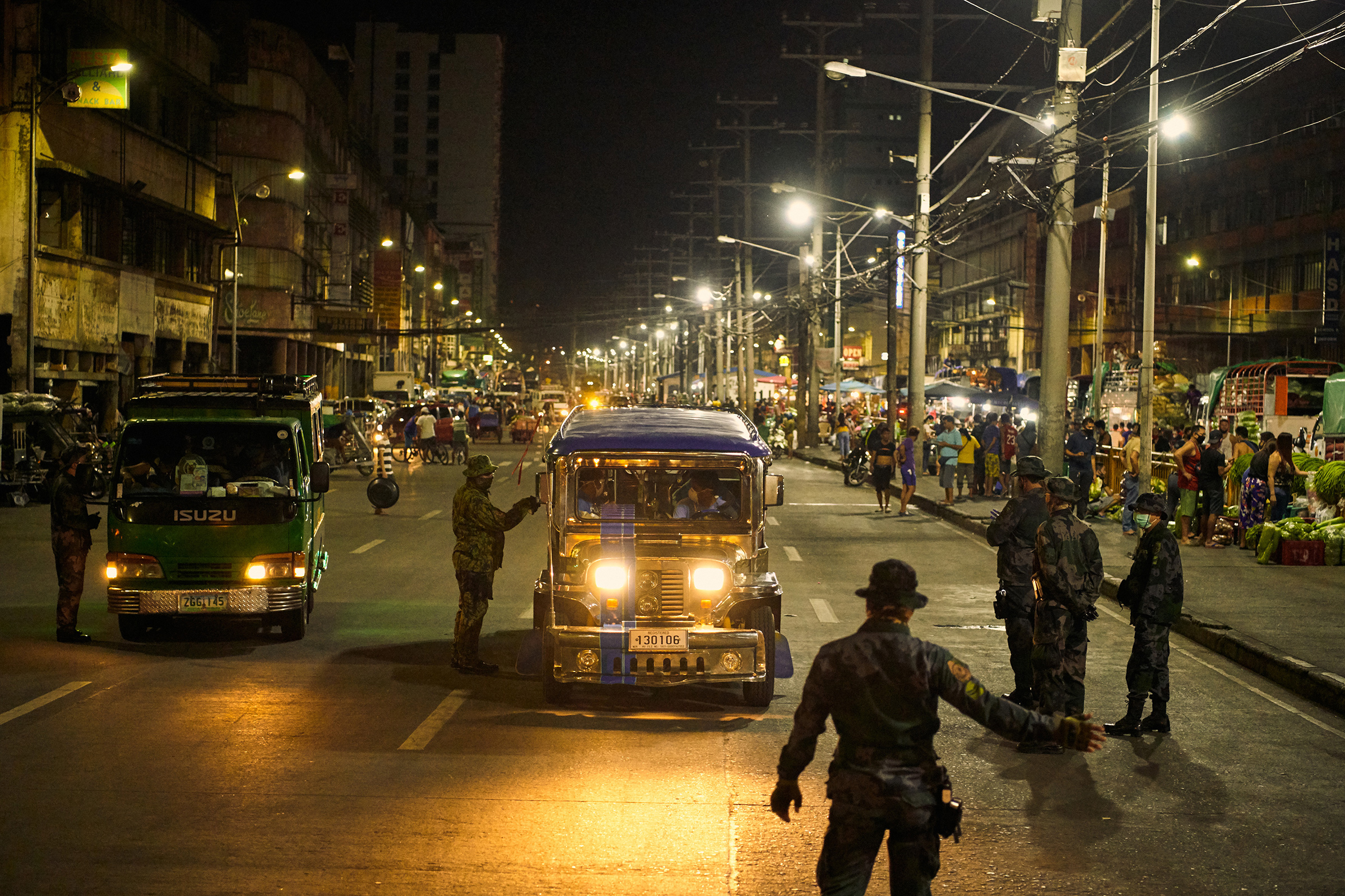 Police check vehicles in Manila during the coronavirus pandemic on March 18, 2020. (Jes Aznar—The New York Times/Redux)