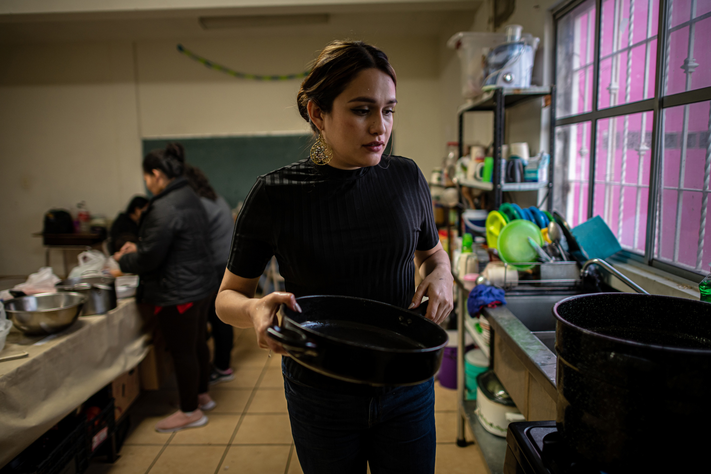 Shelter coordinator Karina Breceda cooks soup with migrant women in the kitchen. “When I see my team, they’re basically on call 24/7,” Breceda says. “There’s a lot of peace, and a lot of healing with the work that they’re doing."