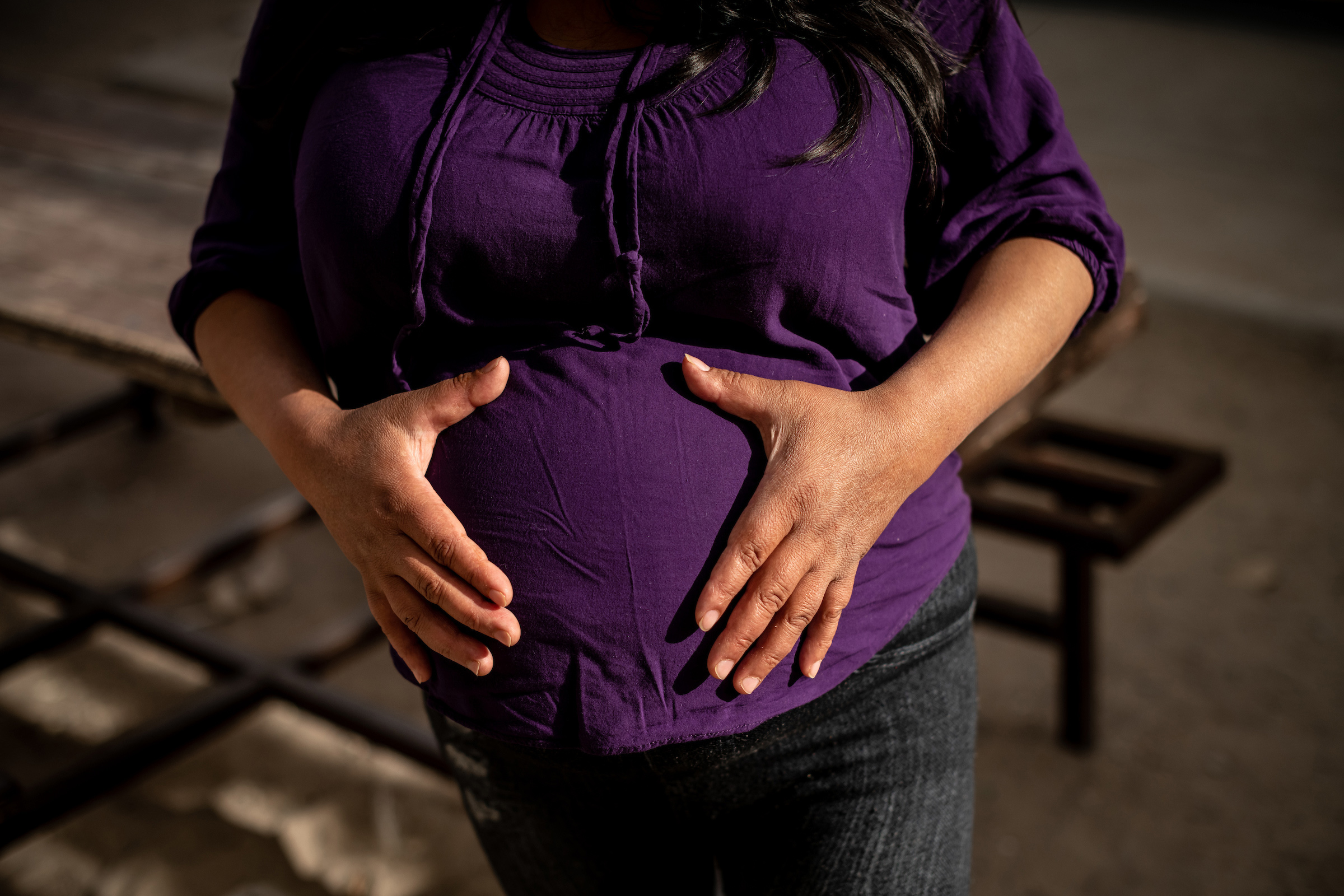 Lina, a migrant from Guatemala, poses for a portrait at 35 weeks pregnant. She is receiving support from the Las Zadas pregnancy project and is living with her daughter at the San Juan Apóstol migrant shelter.