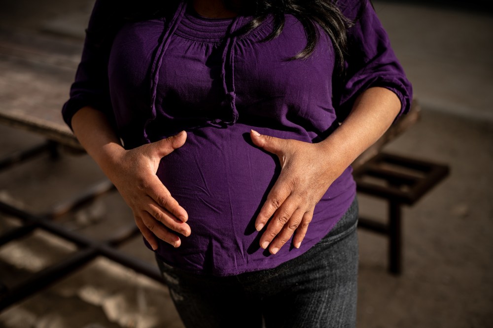 Lina, a migrant from Guatemala, poses for a portrait at 35 weeks pregnant. She is receiving support from the Las Zadas pregnancy project and is living with her daughter at the San Juan ApÃ³stol migrant shelter.