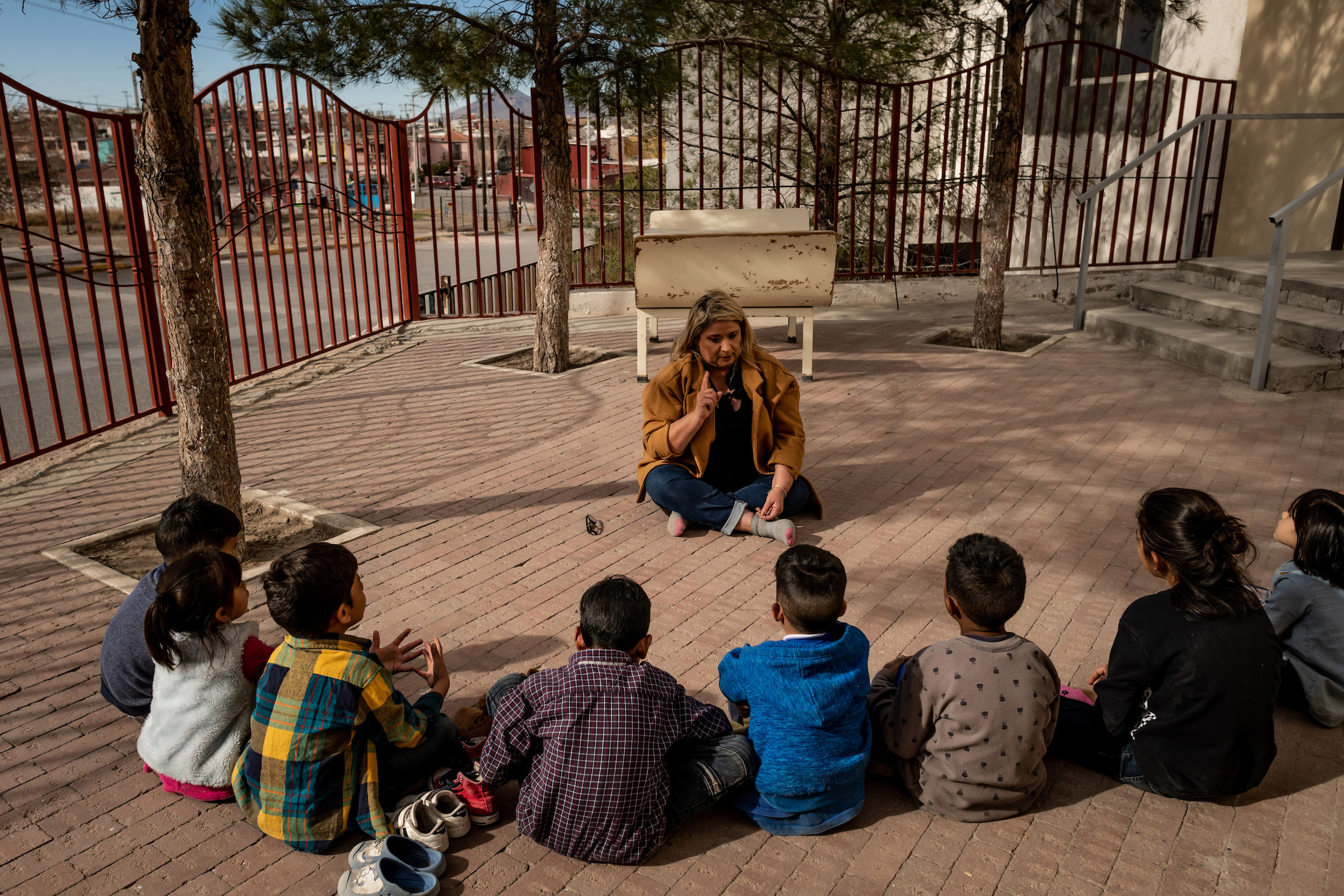 Psychologist Patricia Galarza leads a group therapy session about how to say goodbye to your friends with the children living at the San Juan Apóstol migrant shelter. The children will soon be separated from each other as the government starts processing asylum seekers under MPP into the U.S. (Meridith Kohut for TIME)
