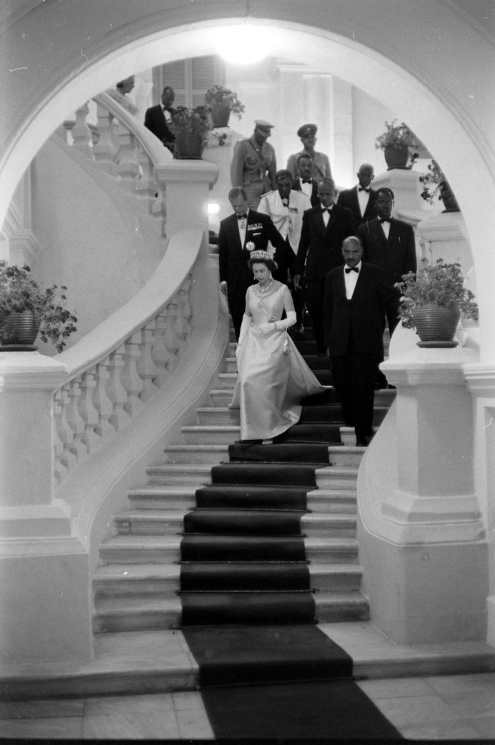 Queen Elizabeth II descending a staircase at a formal gathering during her visit to Ethiopia.