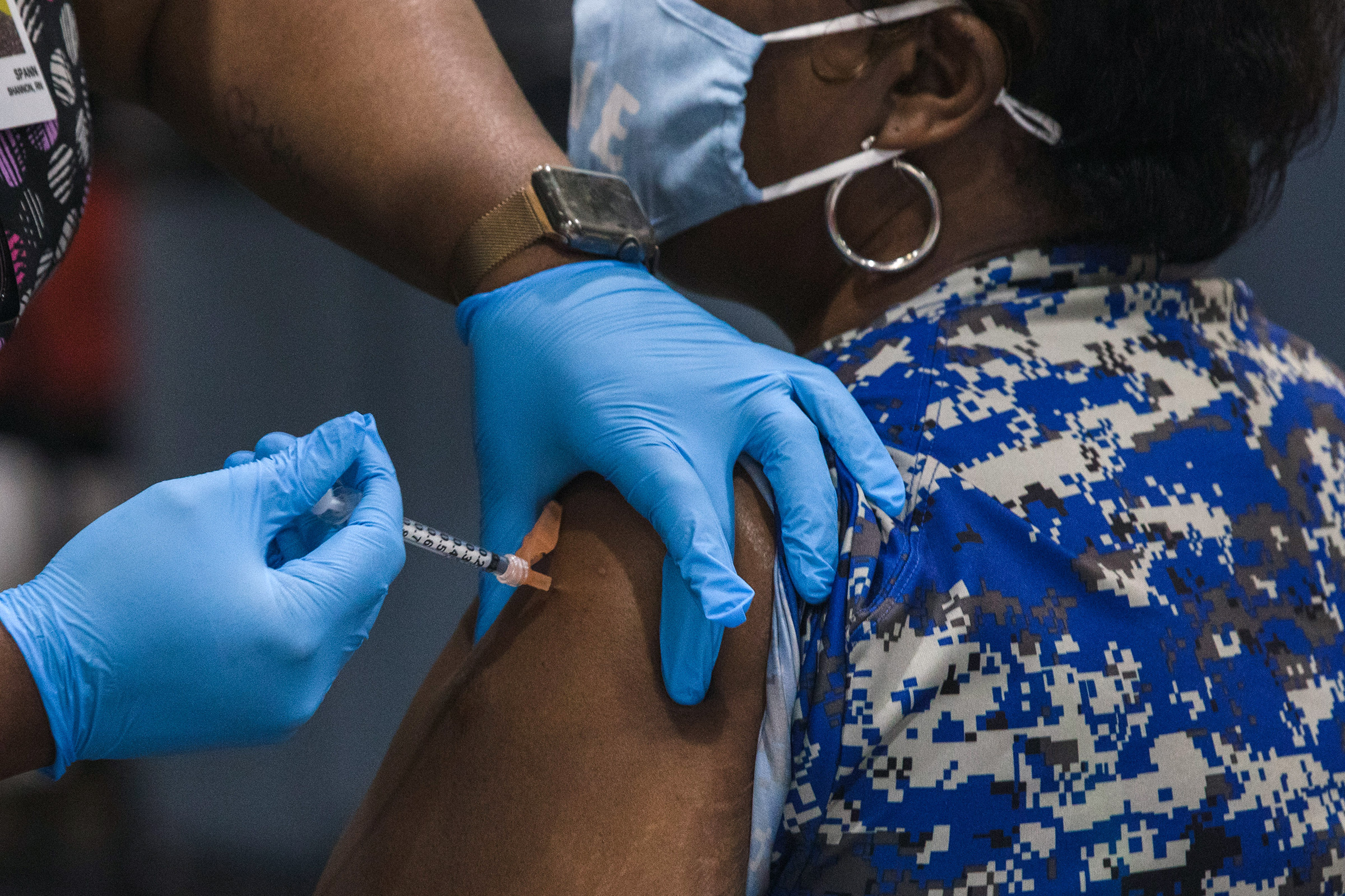 A healthcare worker administers a dose of the Pfizer-BioNTech Covid-19 vaccine to a staff member of the Clarendon School District at Manning High School in Manning, South Carolina, U.S., on Friday, March 12, 2021. (Micah Green—Bloomberg/Getty Images)
