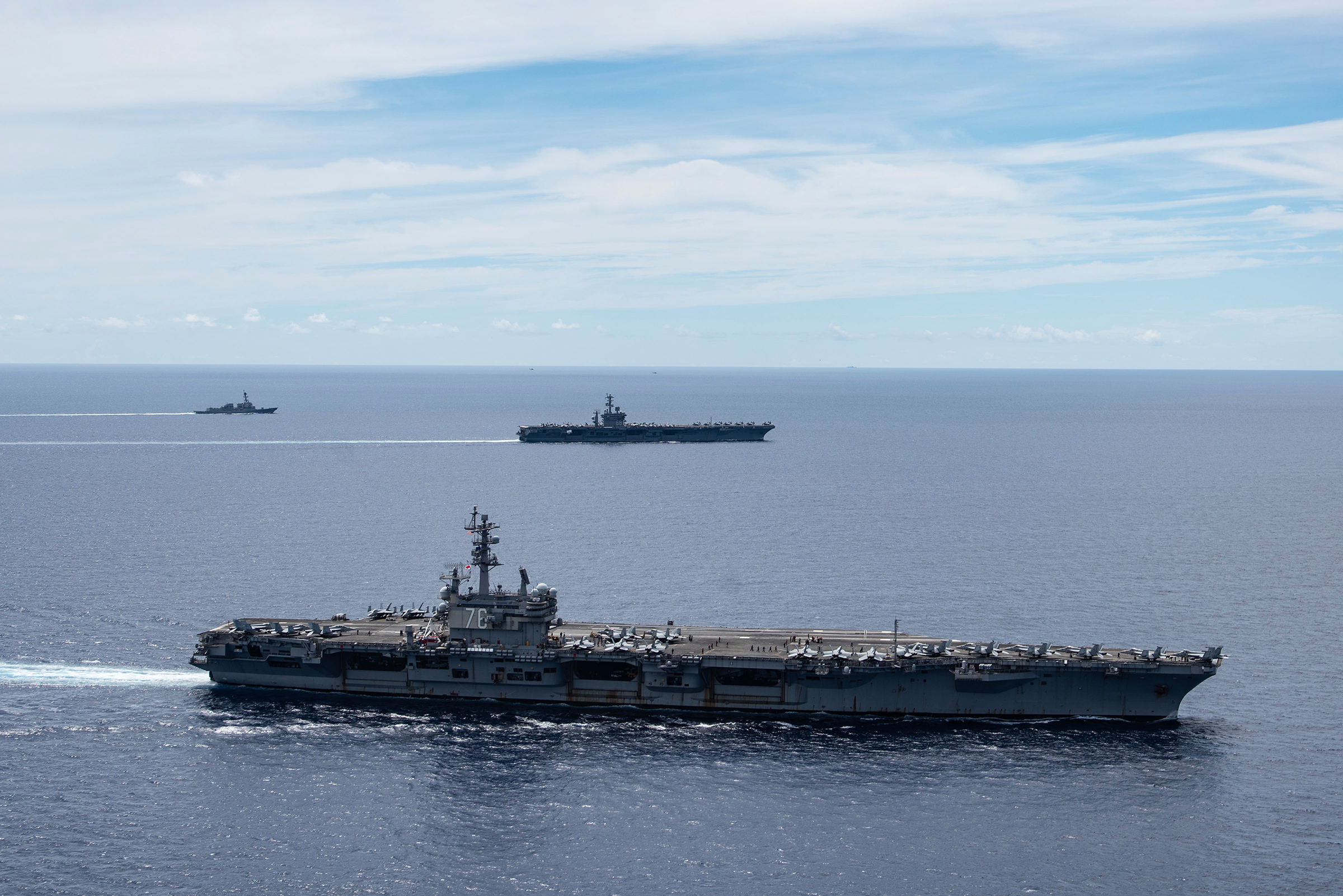 In this July 6, 2020, photo provided by the U.S. Navy, the USS Ronald Reagan (CVN 76, front) and USS Nimitz (CVN 68, rear) Carrier Strike Groups sail together in formation, in the South China Sea (Mass Communication Specialist 3rd Class Jason Tarleton—U.S. Navy/AP)