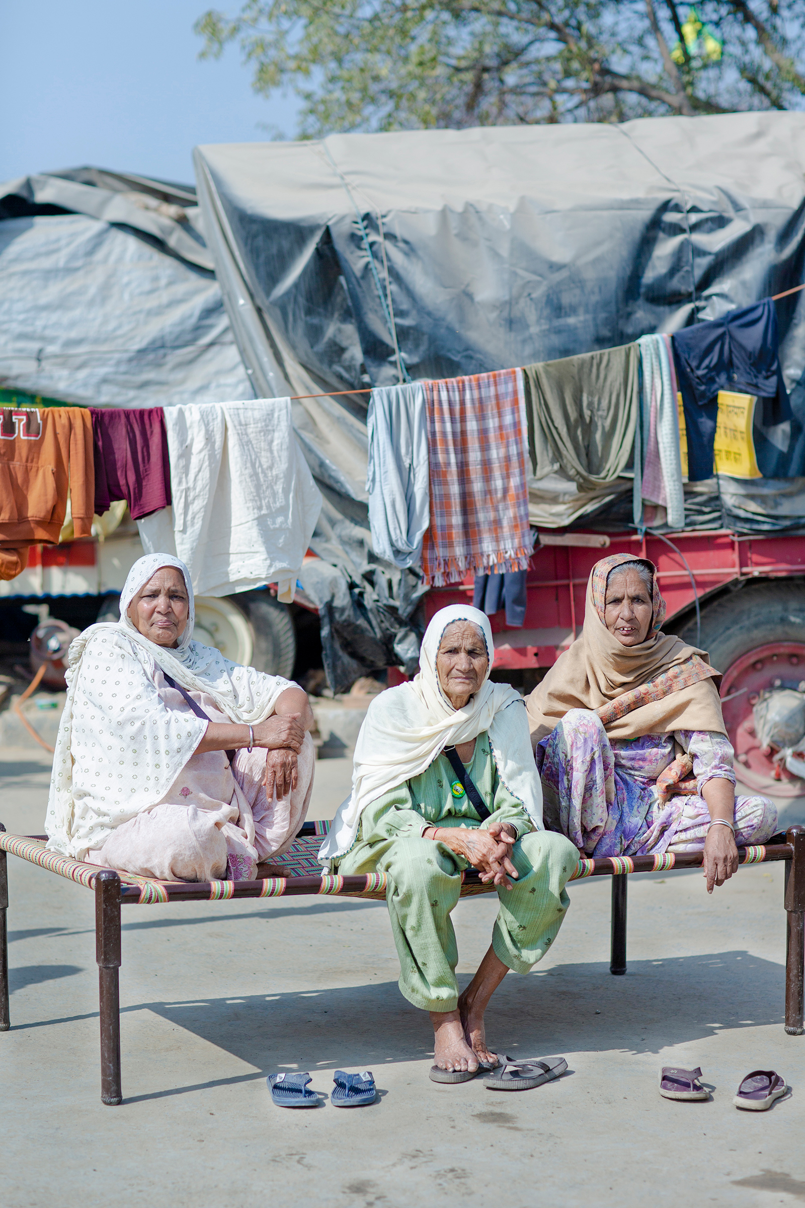 The protests have drawn women of all ages. While some speak onstage, others are simply determined to be present. “I am an illiterate woman,” says Gurmer Kaur, center, at the protests with her friends Surjit Kaur, left, and Jaswant Kaur, right, all in their mid-70s. “I cannot talk well, but I can sit tight—and I will sit here till the next elections if these laws are not called off.” (Kanishka Sonthalia for TIME)