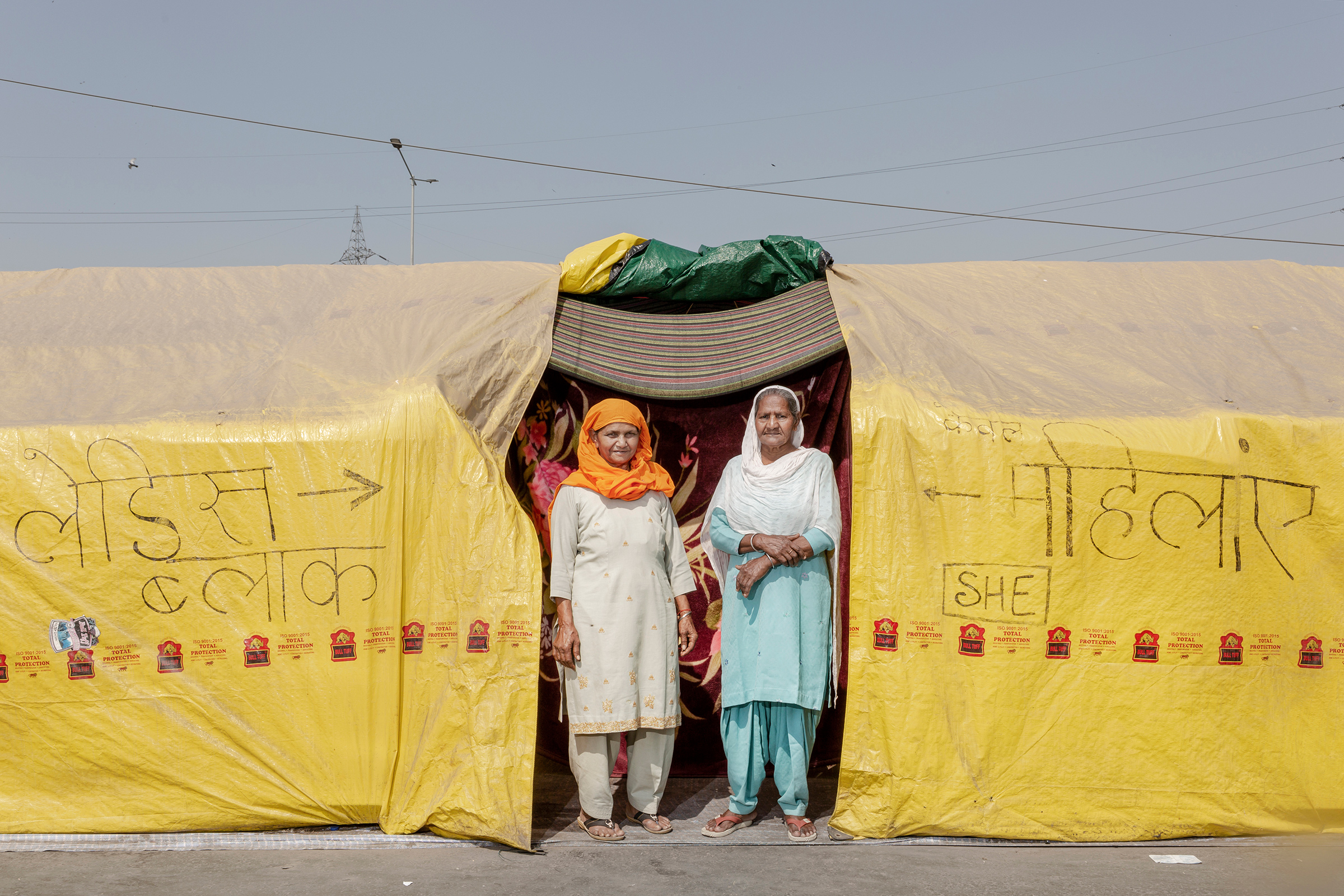 Sarjit Kaur, left, and Dilbeer Kaur, right, from Rampur, Uttar Pradesh, have been at the protests for two months. “We are here to show solidarity and support,” Dilbeer says. Prime Minister Modi is “making us leave our farms and sit here to fight for our rights. We are here to get these laws repealed, and we will be here till we get it done.” (Kanishka Sonthalia for TIME)