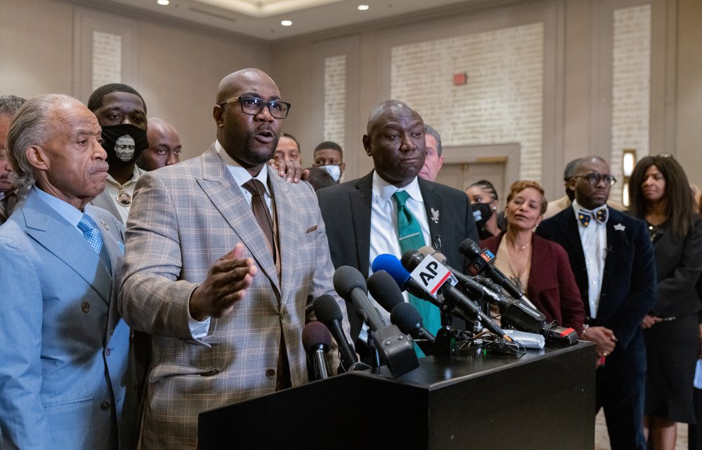 George Floyd's brother, Philonise Floyd, is flanked by the Rev. Al Sharpton, left, and Attorney Ben Crump during a news conference after the verdicts were announced.