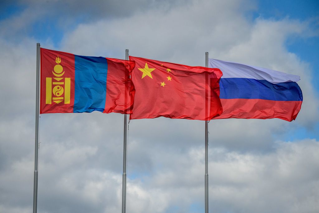 The flags of Mongolia, China and Russia fly in the wind during the Vostok-2018 (East-2018) military drills at Tsugol training ground not far from the borders with China and Mongolia in Siberia, on September 13, 2018. (MLADEN ANTONOV/AFP via Getty Images)