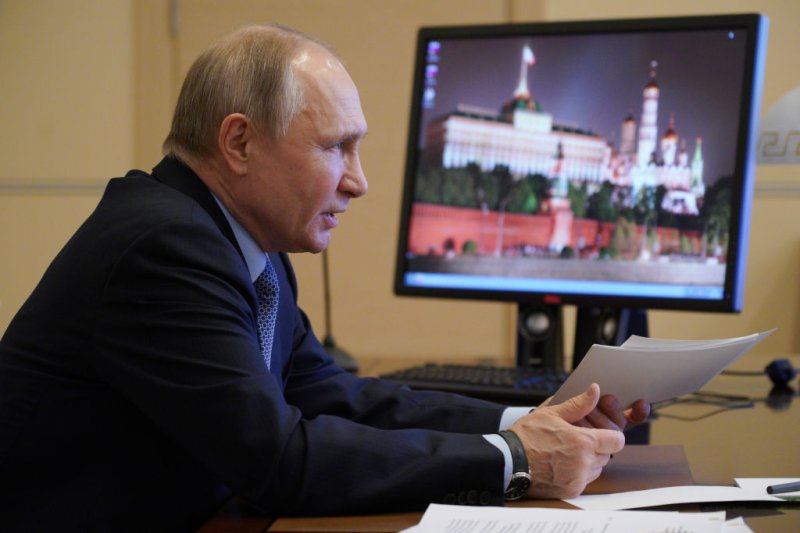 Russias President Vladimir Putin is seen in his office in Novo-Ogaryovo during a video-conference meeting of Russias Council for Interethnic Relations on March 30, 2021.