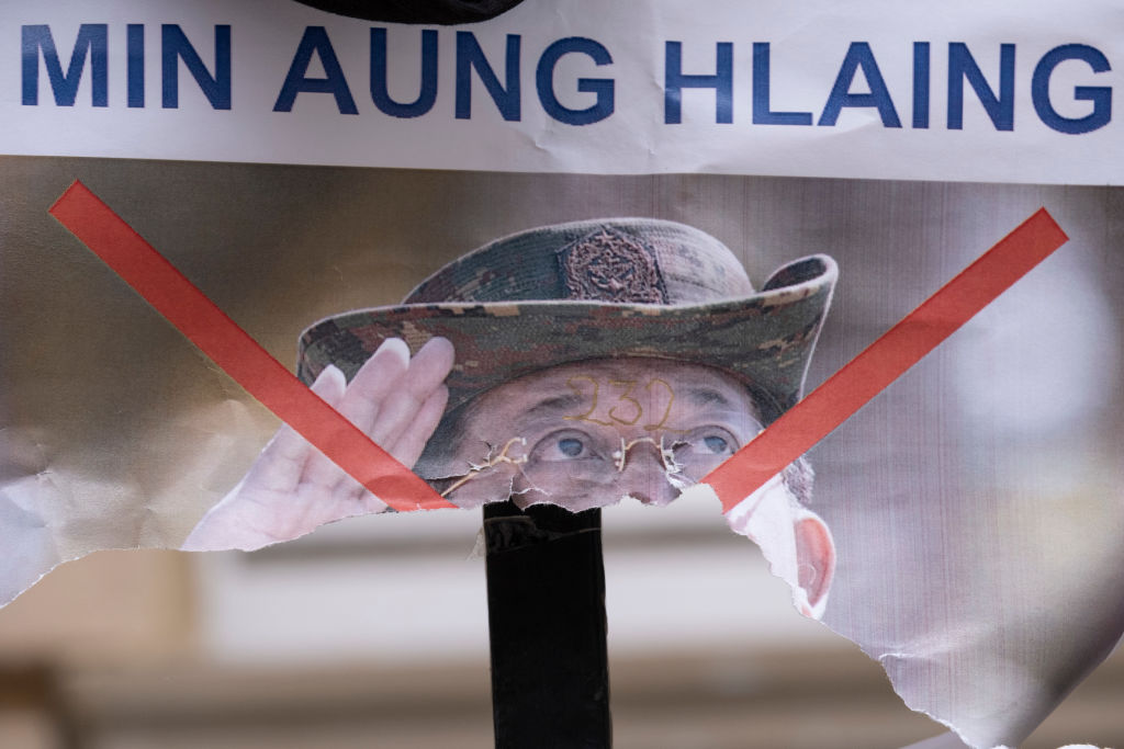 A poster showing de-facto leader of Myanmar's military government, General Min Aung Hlaing, is torn in half on railings outside the country's embassy, on 8th April 2021, in London, England. (Richard Baker / In Pictures via Getty Images)