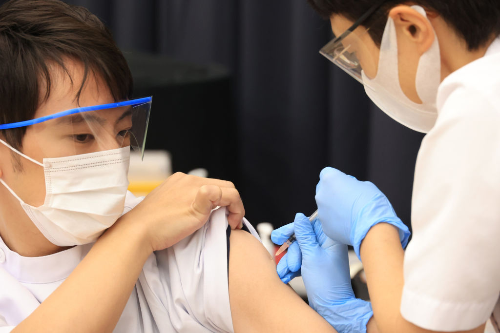 A medical worker receives a dose of COVID-19 vaccine at the Tokyo Metropolitan Cancer and Infectious Diseases Center Komagome Hospital on March 05, 2021 in Tokyo, Japan. (Yoshikazu Tsuno—Pool/Getty Images)
