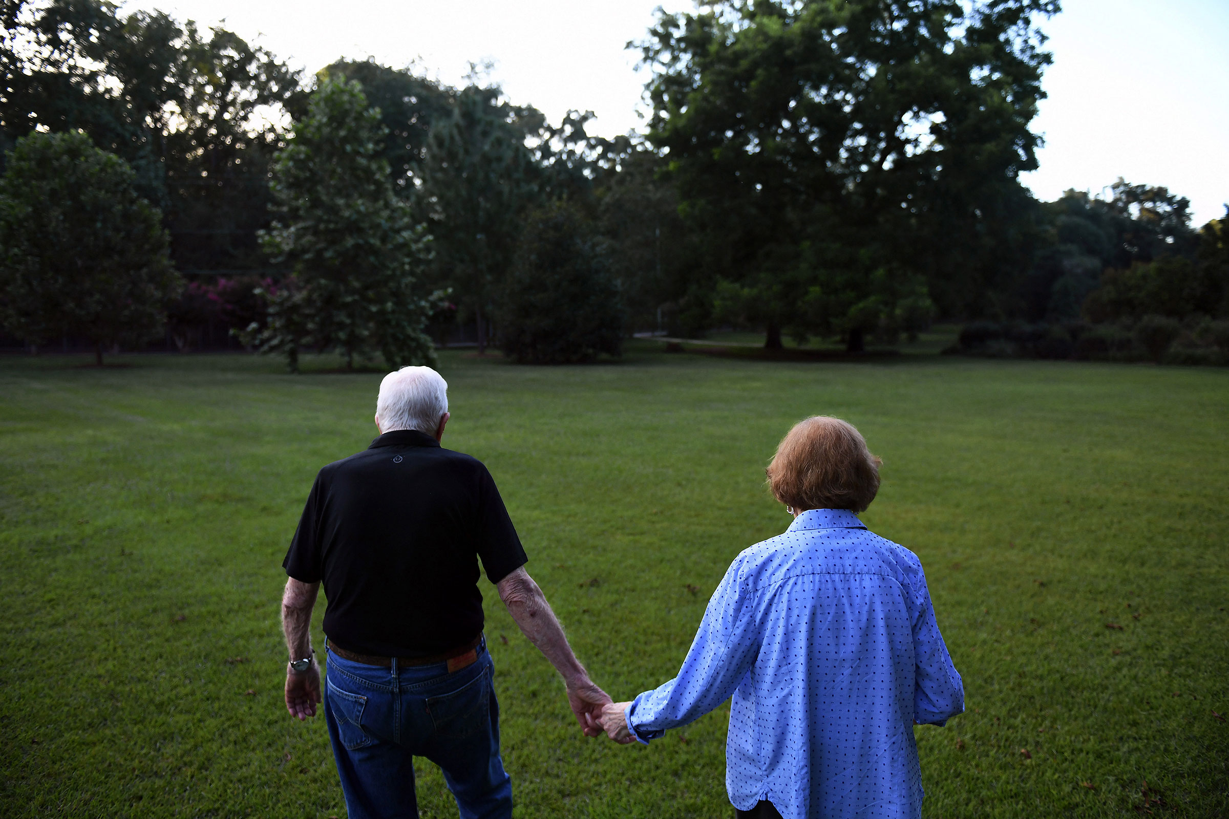 Former President Jimmy Carter walks with his wife, former First Lady, Rosalynn Carter towards their home following dinner at a friend's home in Plains, GA, on Aug. 4, 2018. Born in Plains, GA, President Carter stayed in the town following his presidency.