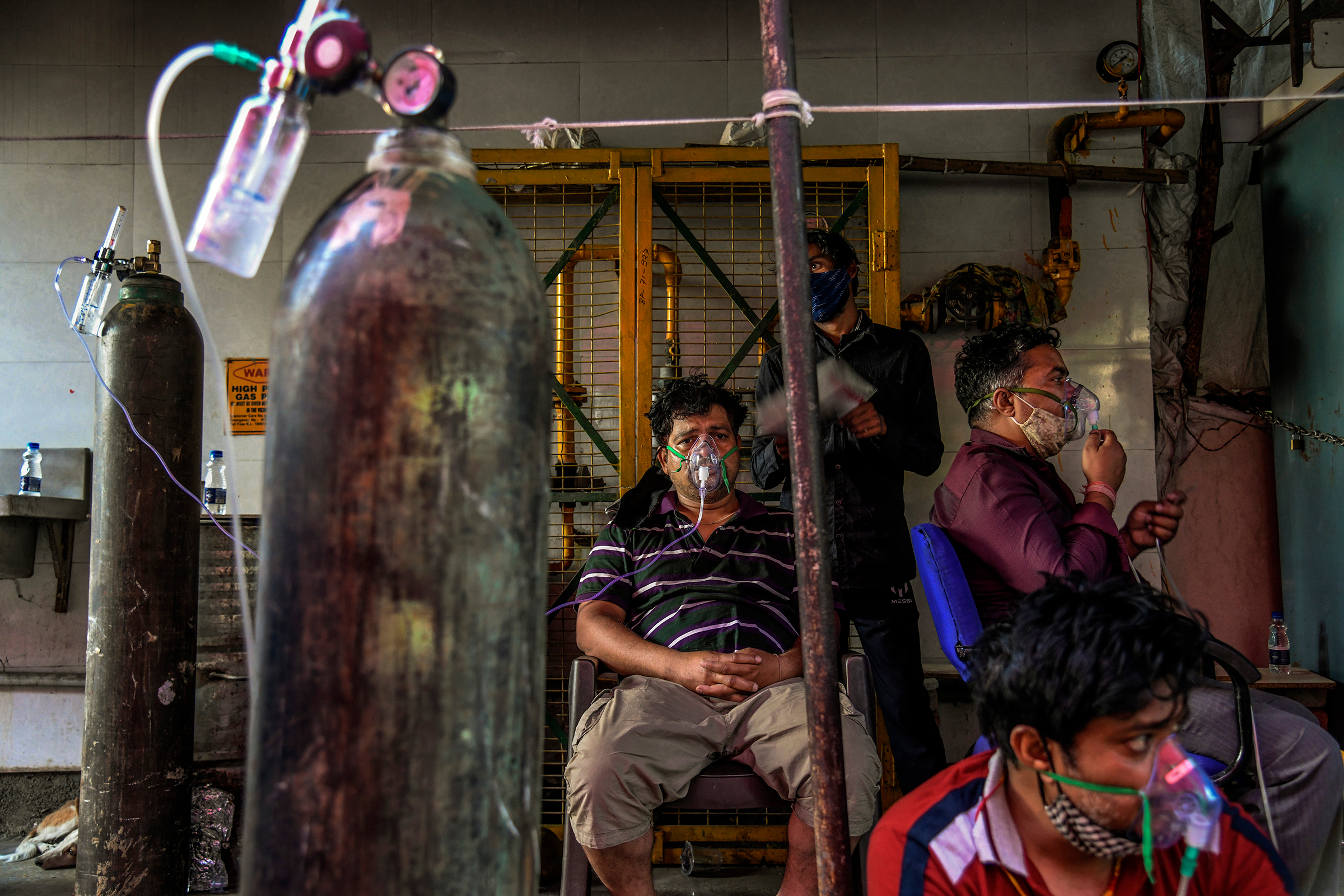 With hospitals full, COVID-19 patients receive oxygen outside a Sikh temple in Delhi on April 25. (Atul Loke—The New York Times/Redux)