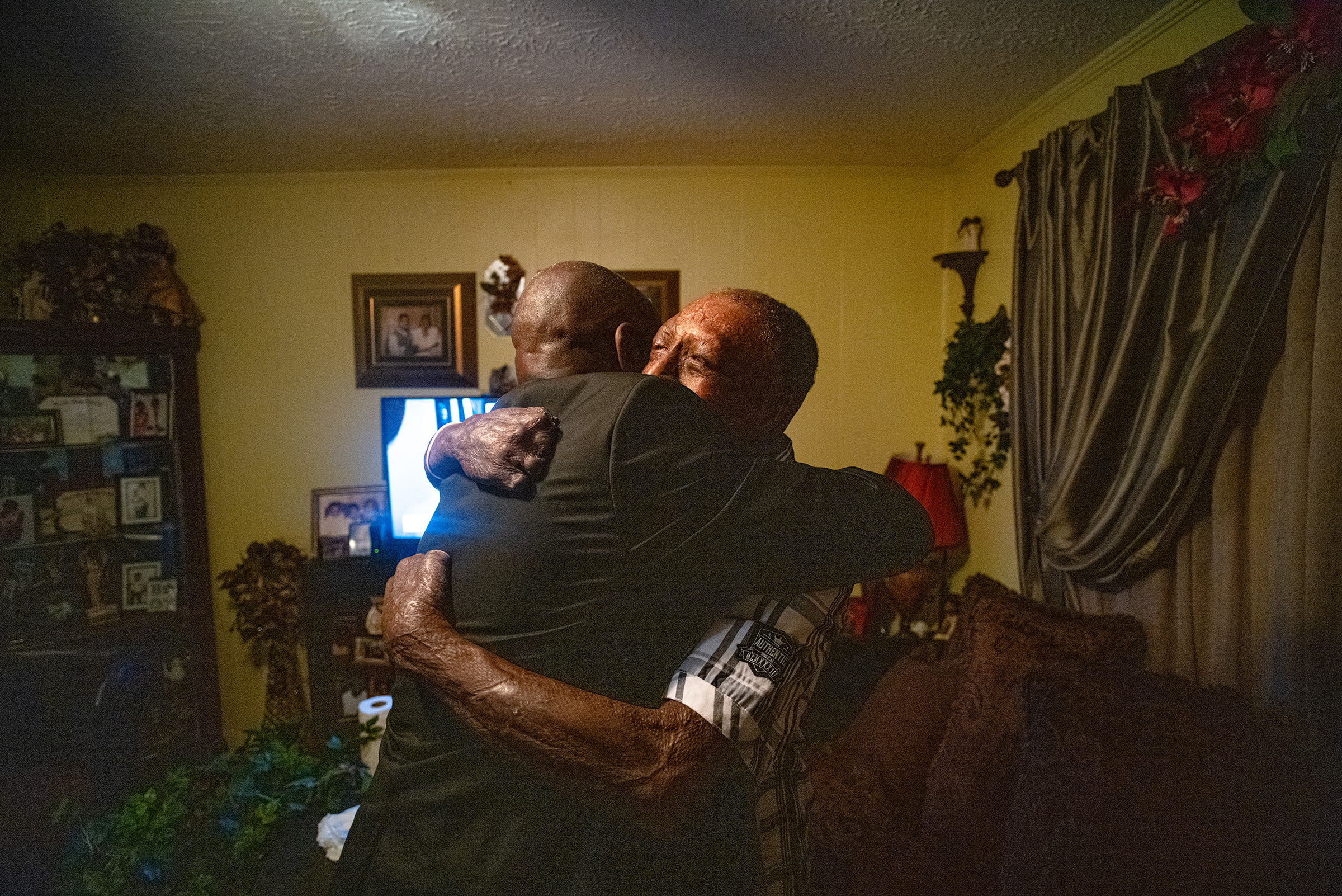 Crump hugs Curtis Jones, a client who was severely burned after an explosion at a manufacturing facility supplying the Department of Defense, at home in Tallahassee, Fla., on April 3. (Ruddy Roye for TIME)