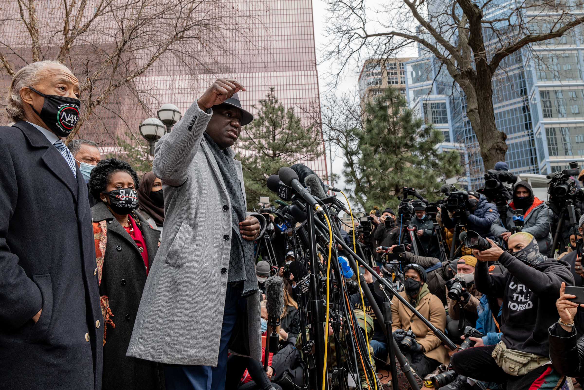 Attorney Ben Crump speaks before the Rev. Al Sharpton and leads a prayer outside of the courthouse during closing arguments in the Chauvin trial in Minneapolis on April 19. (Ruddy Roye for TIME)
