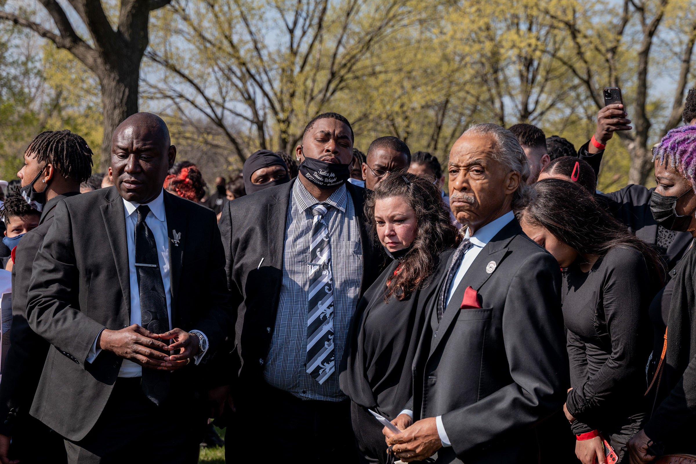 Aubrey and Katie Wright, the parents of Daunte Wright, stand with Crump (far left) and Sharpton (far right), at Lakewood Cemetery after their son's funeral in Minneapolis on April 22.