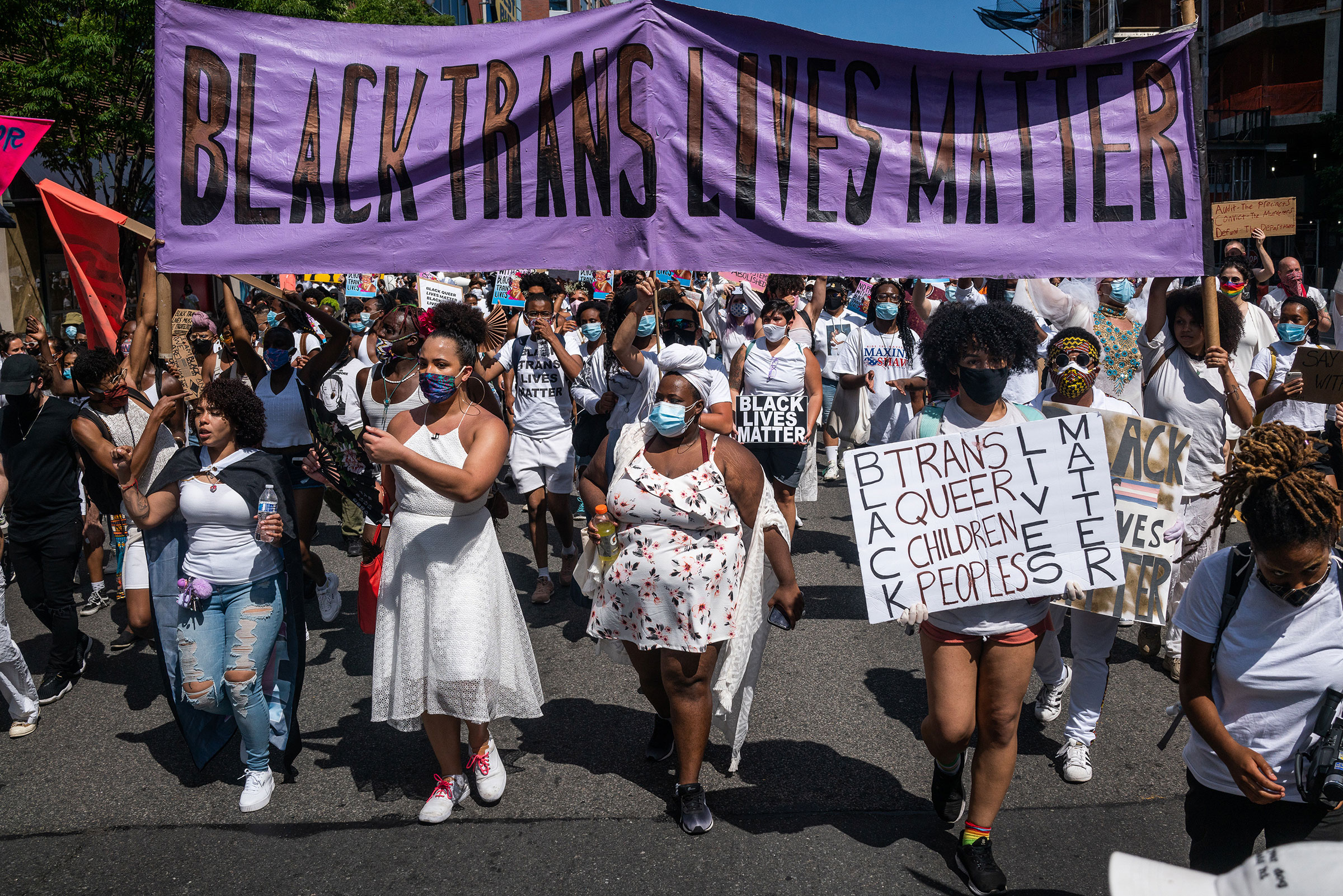 Demonstrators carry a banner reading "Black Trans Lives Matter" during a march in New York, on June 14, 2020.