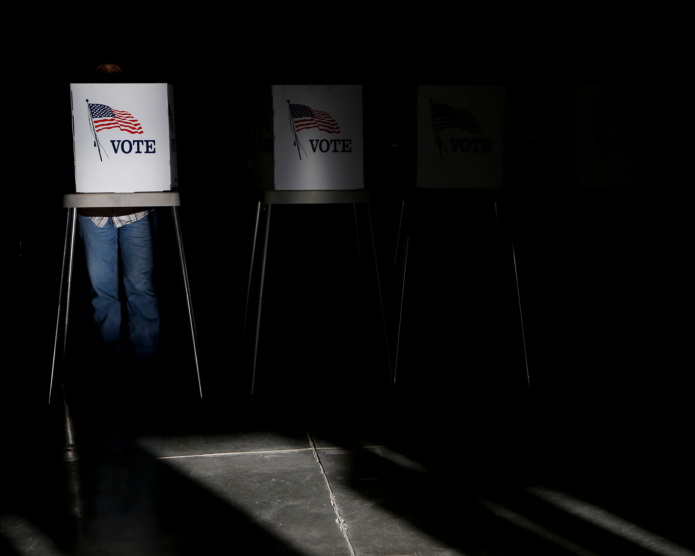 Voting booths are illuminated by sunlight as voters cast their ballots at a polling place. (Jae C. Hong—AP)