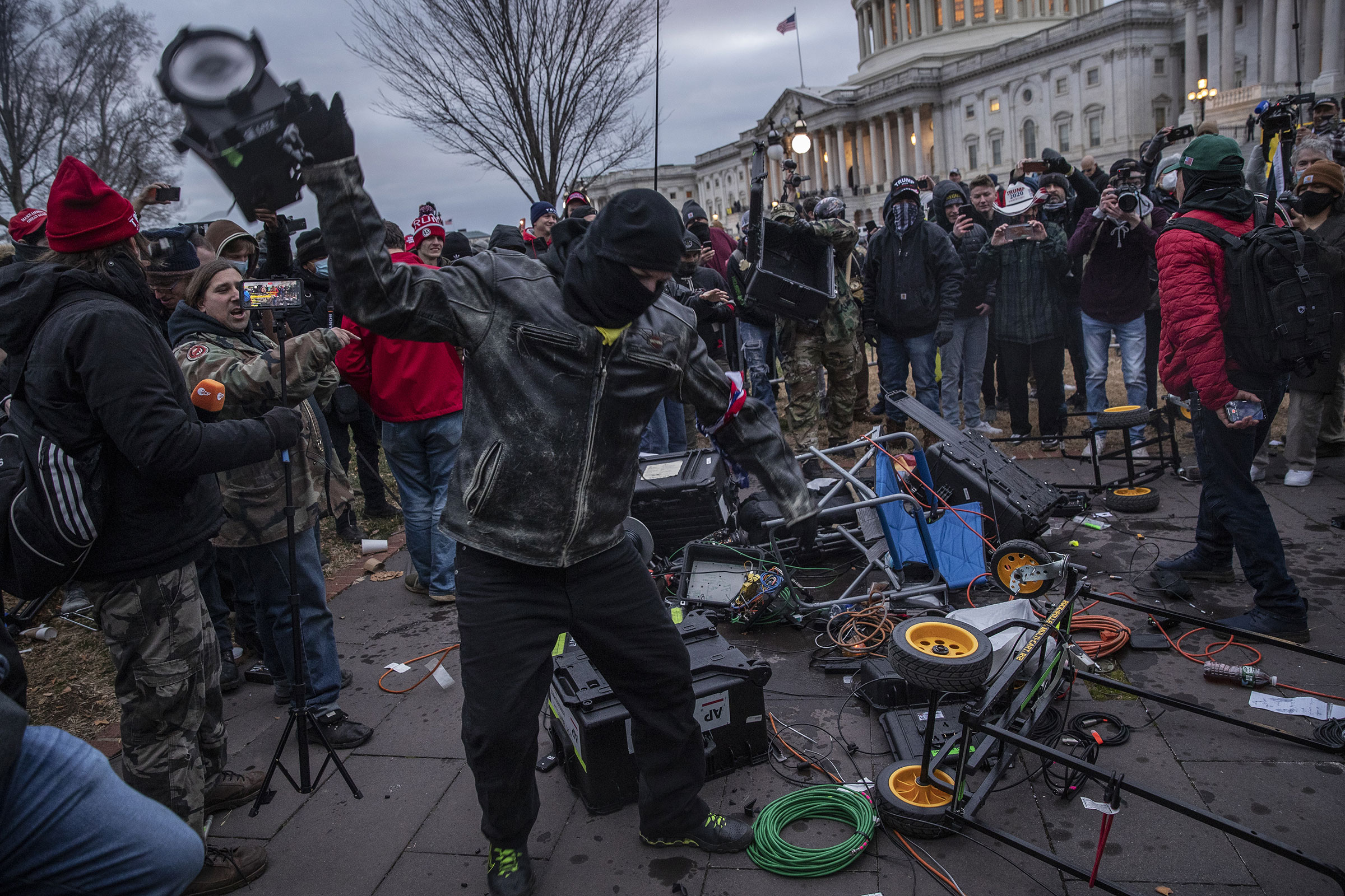 Demonstrators destroy broadcast video equipment outside the U.S. Capitol building after they earlier stormed the building in Washington, DC, U.S., on Wednesday, Jan. 6, 2021. (Victor J. Blue—Bloomberg/Getty Images)