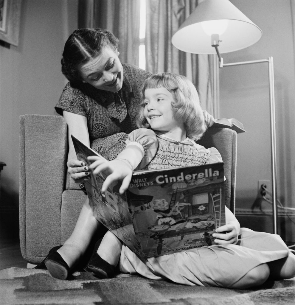 A little girl reading a 'Cinderella' book, circa 1950 (Rae Russel—Archive Photos/Getty Images)