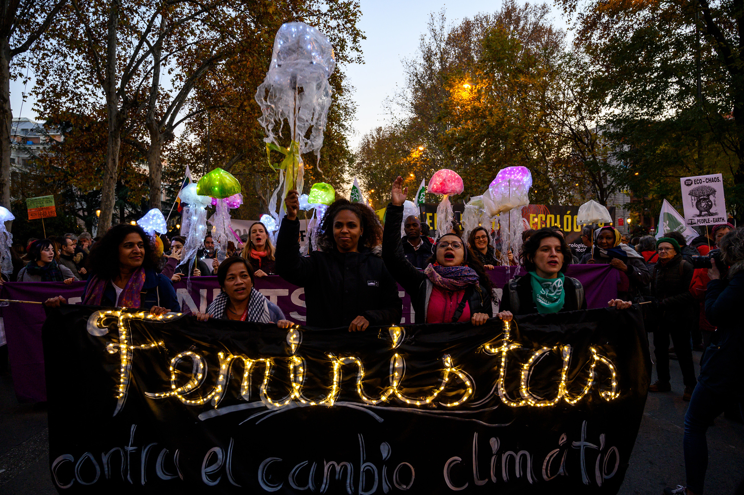 Women hold a banner that reads “Feminists against climate change” at a 2019 protest in Madrid.