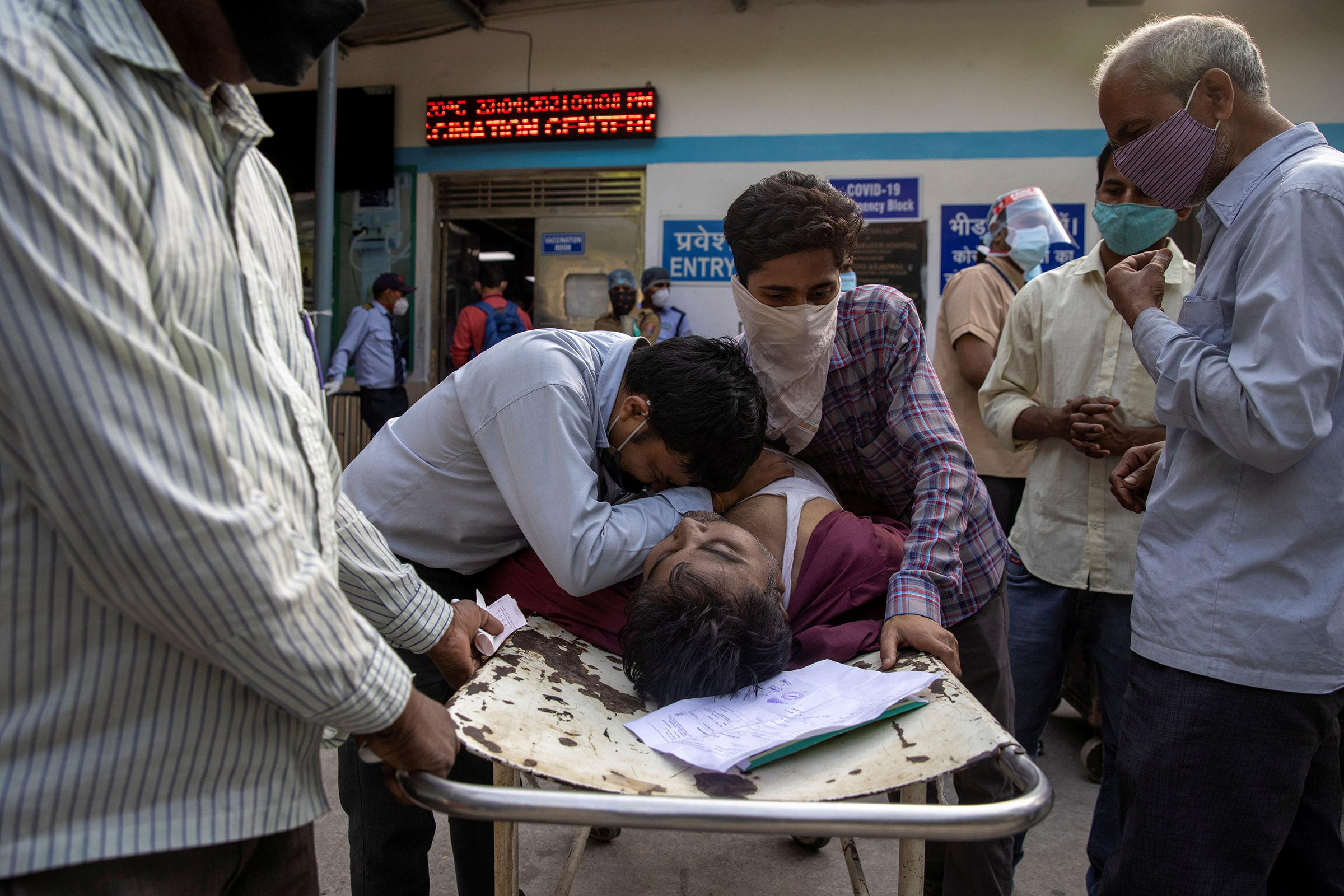 Family members mourn after Shayam Narayan is declared dead outside the COVID-19 casualty ward at Guru Teg Bahadur Hospital in New Delhi on April 23.