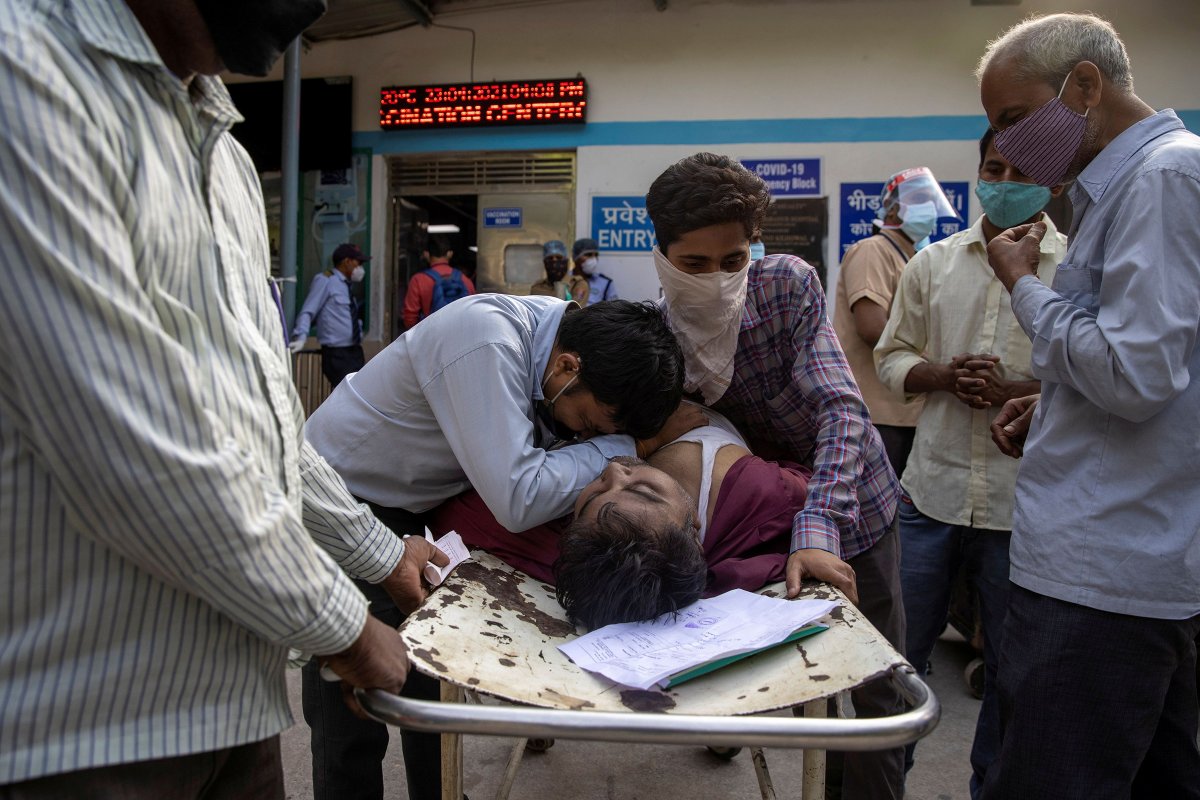 Family members mourn after Shayam Narayan, a 45-year-old COVID-19 patient and father of five, is declared dead outside the COVID-19 casualty ward at Guru Teg Bahadur Hospital in Delhi on April 23.