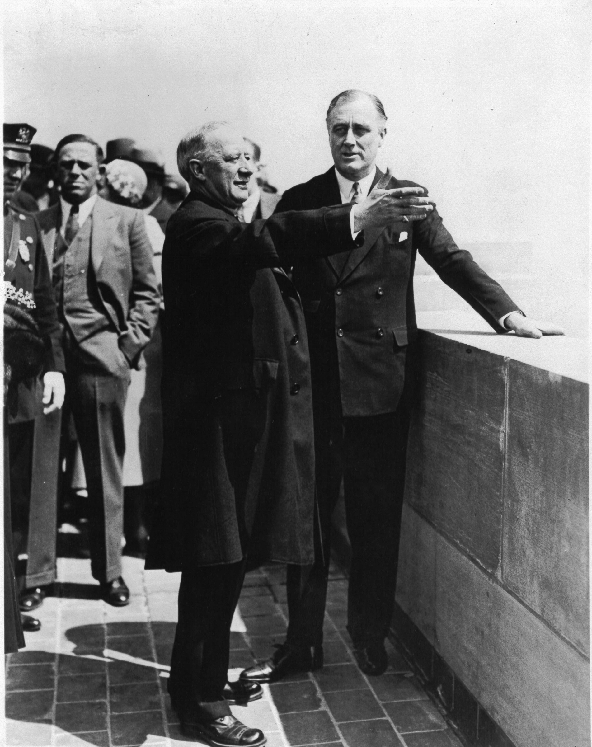 Ex-Governor Smith points out the sights of the city to Governor Roosevelt from 1 of 2 observation floors on May 1, 1931.