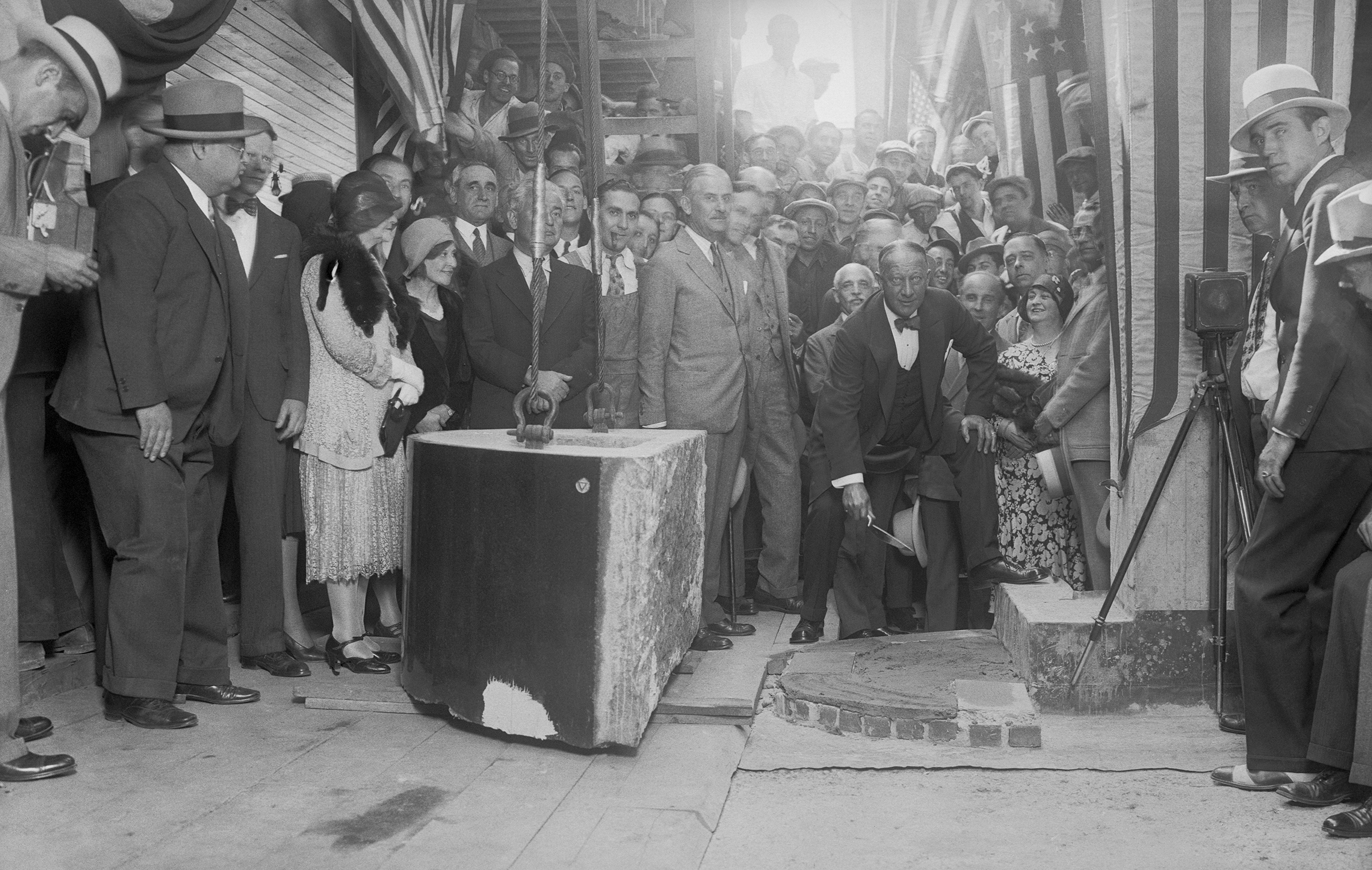 As possessor of a gold membership card in the bricklayers' union, Alfred Smith performed a thorough job when he laid the cornerstone for the Empire State Building on Fifth avenue and 34th street, New York City, before a crowd of onlookers on Sept. 9, 1930.