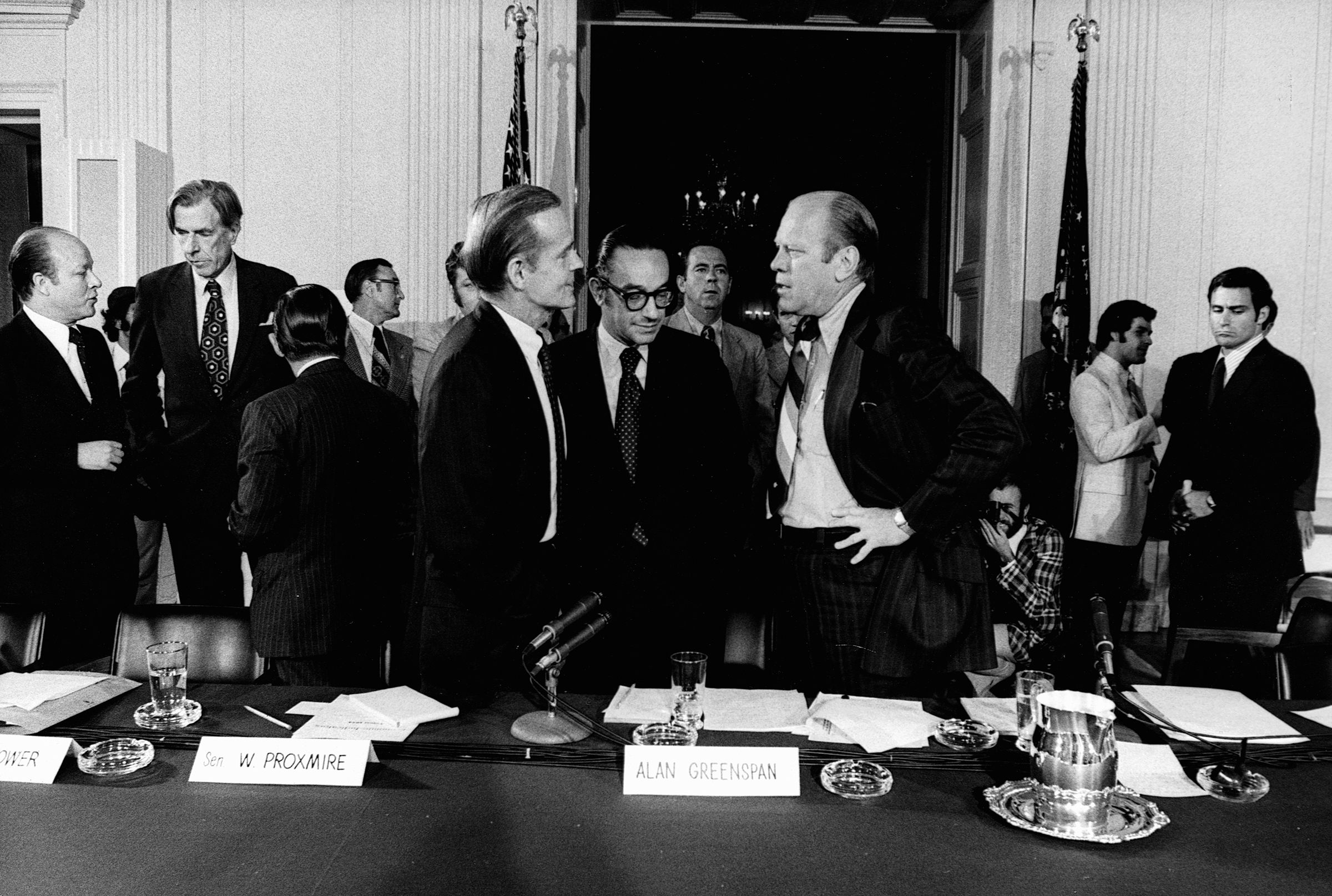 United States President Gerald Ford converses with economists and senators, including Alan Greenspan (center) in a White House conference room on Sept. 5, 1974